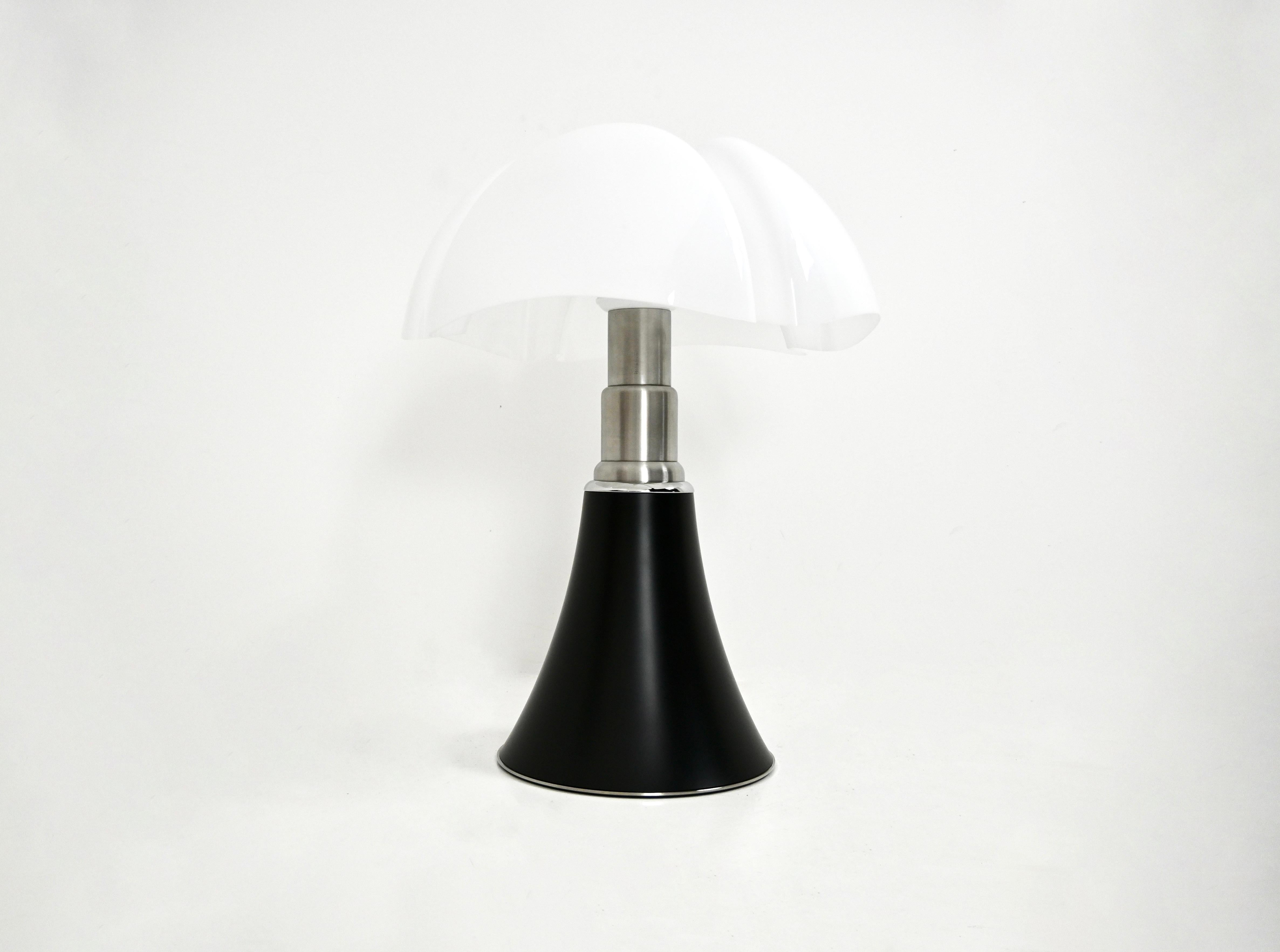 Black lamp in metal and plastic by Gae Aulenti. Adjustable in height min: 70cm max: 90cm 
Stamped under the lamp.
FOR SHIPPING, REQUEST US FOR RECEIVE THE BEST PRICE
