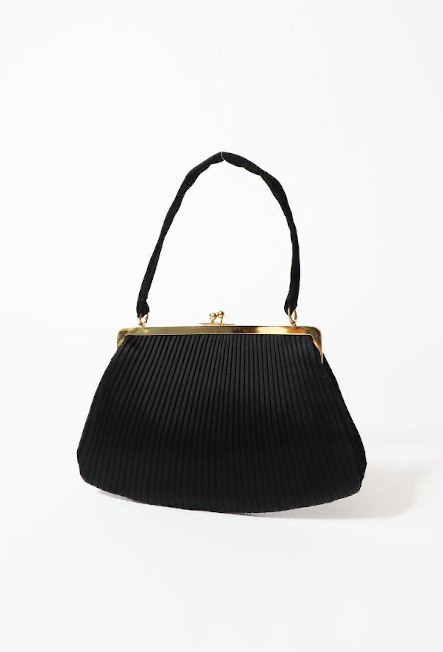 Black evening black handbag featuring a satin pleated textured silk pattern,  a satin top handle, gold-tone hardware, satin interior lining and slot pocket.
Length 10.6in. (27 cm)
Heigh 7in. (18cm)
Width 1.2in (3cm)
In good vintage condition. 
We