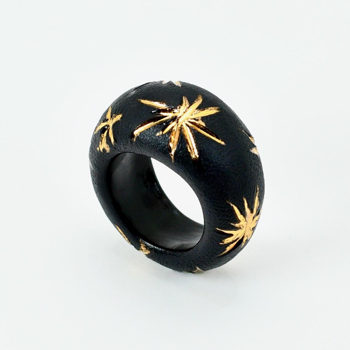Porcelain  24K gold embellishment  Handmade in London

This porcelain ring is an exquisite piece of wearable art and surely a rare find. The ring is made from onyx black porcelain giving it a classy and earthy appearance. The shape of the ring is