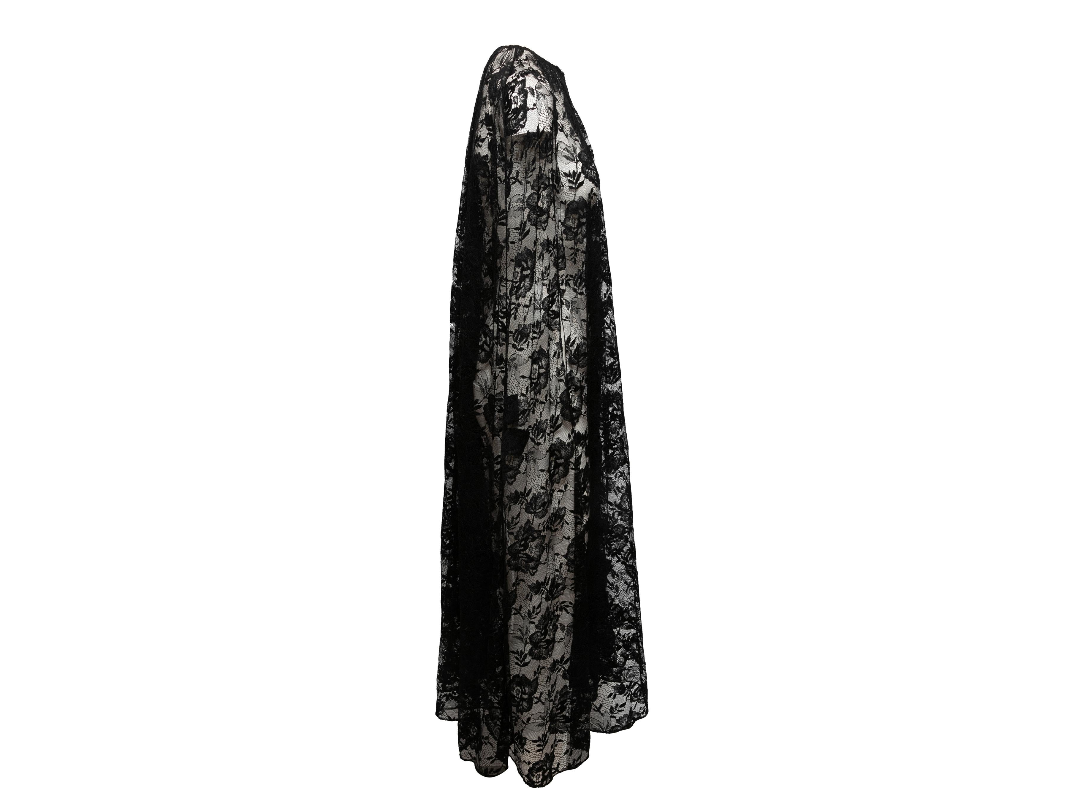 Black sheer chantilly lace long cape by Prada. Circa 2019. Crew neck. Front neckline closure. 19.5