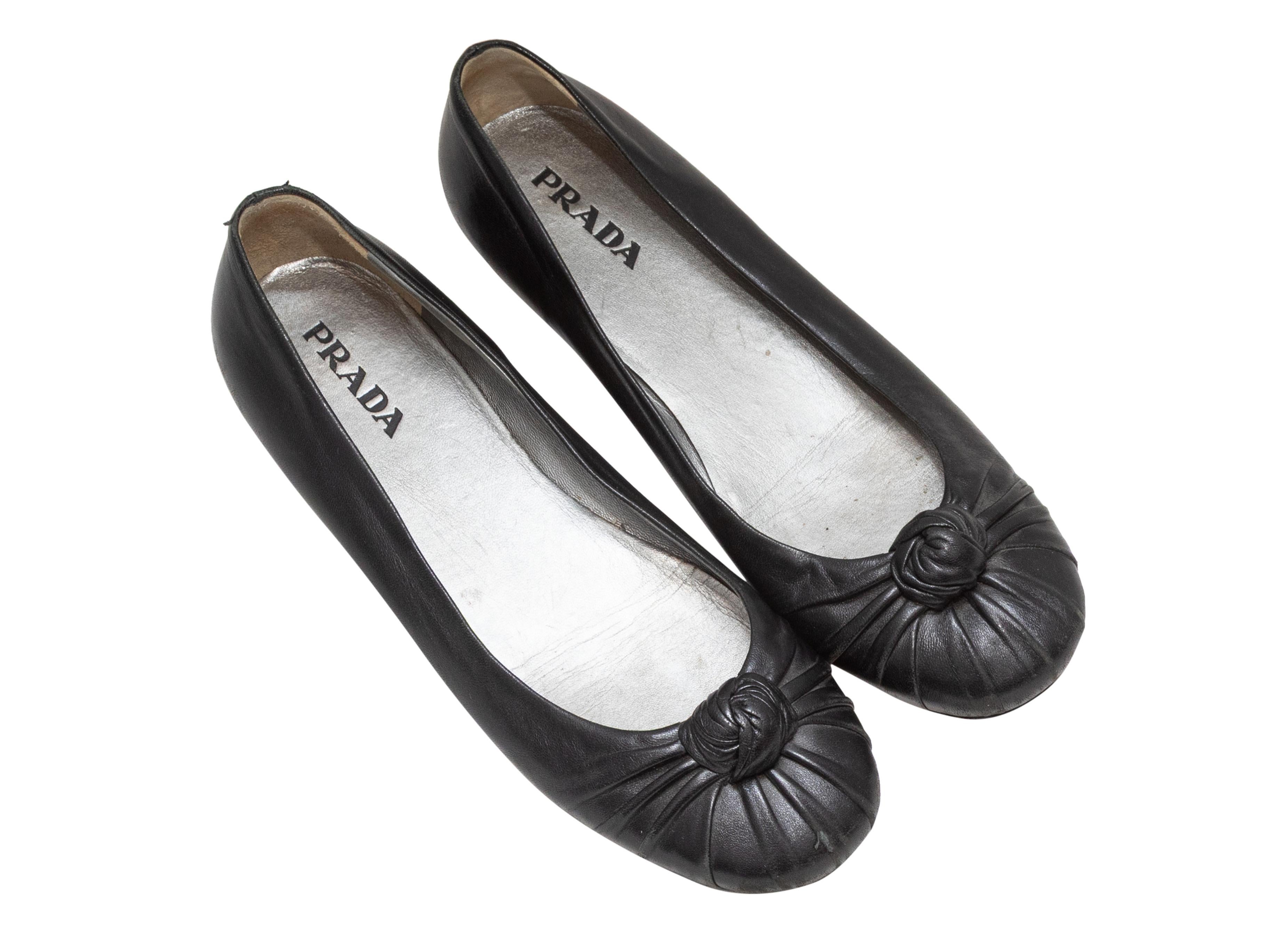 Black leather knotted ballet flats by Prada. 0.25