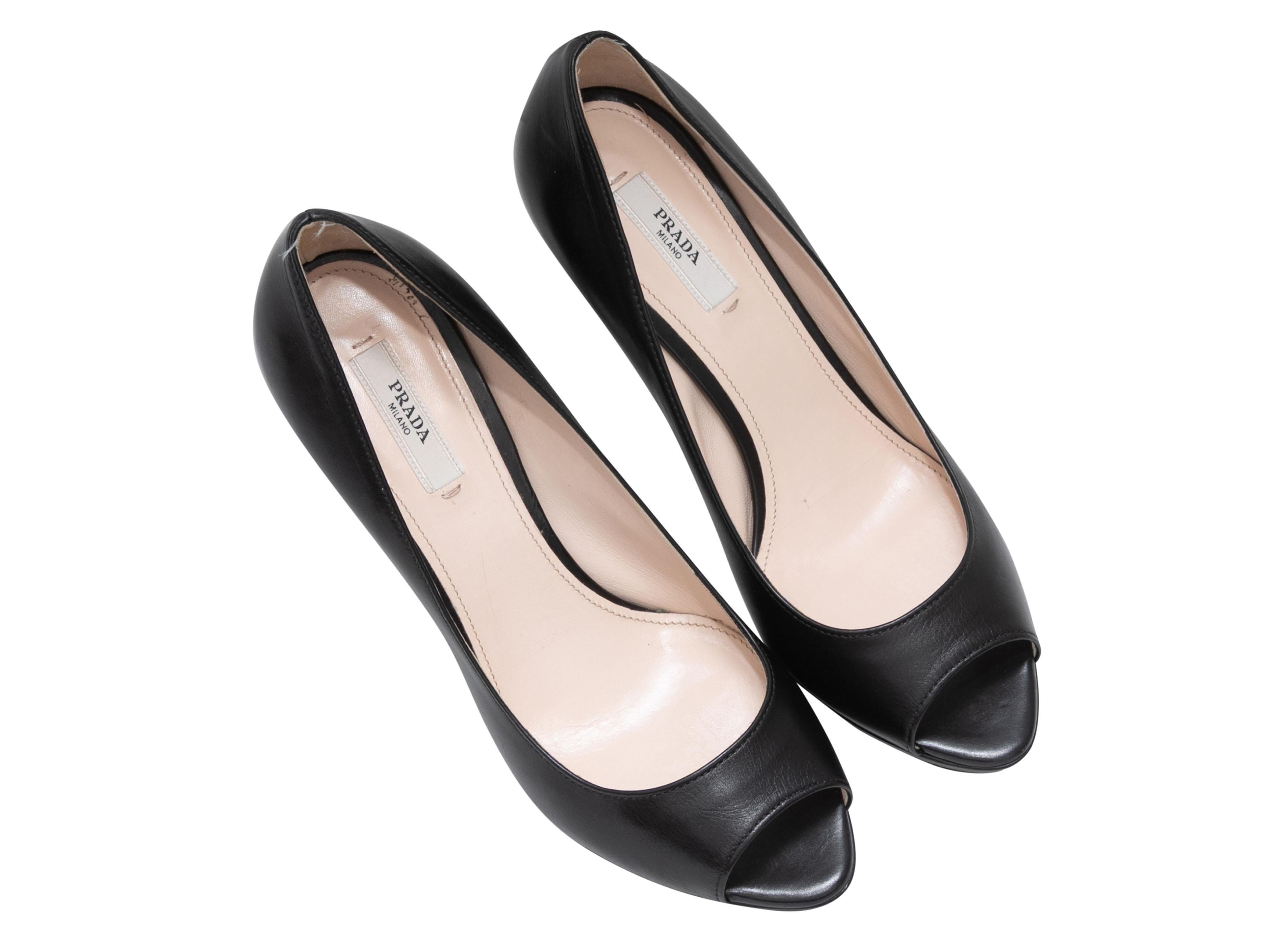 Black patent peep-toe pumps by Prada. 3.25