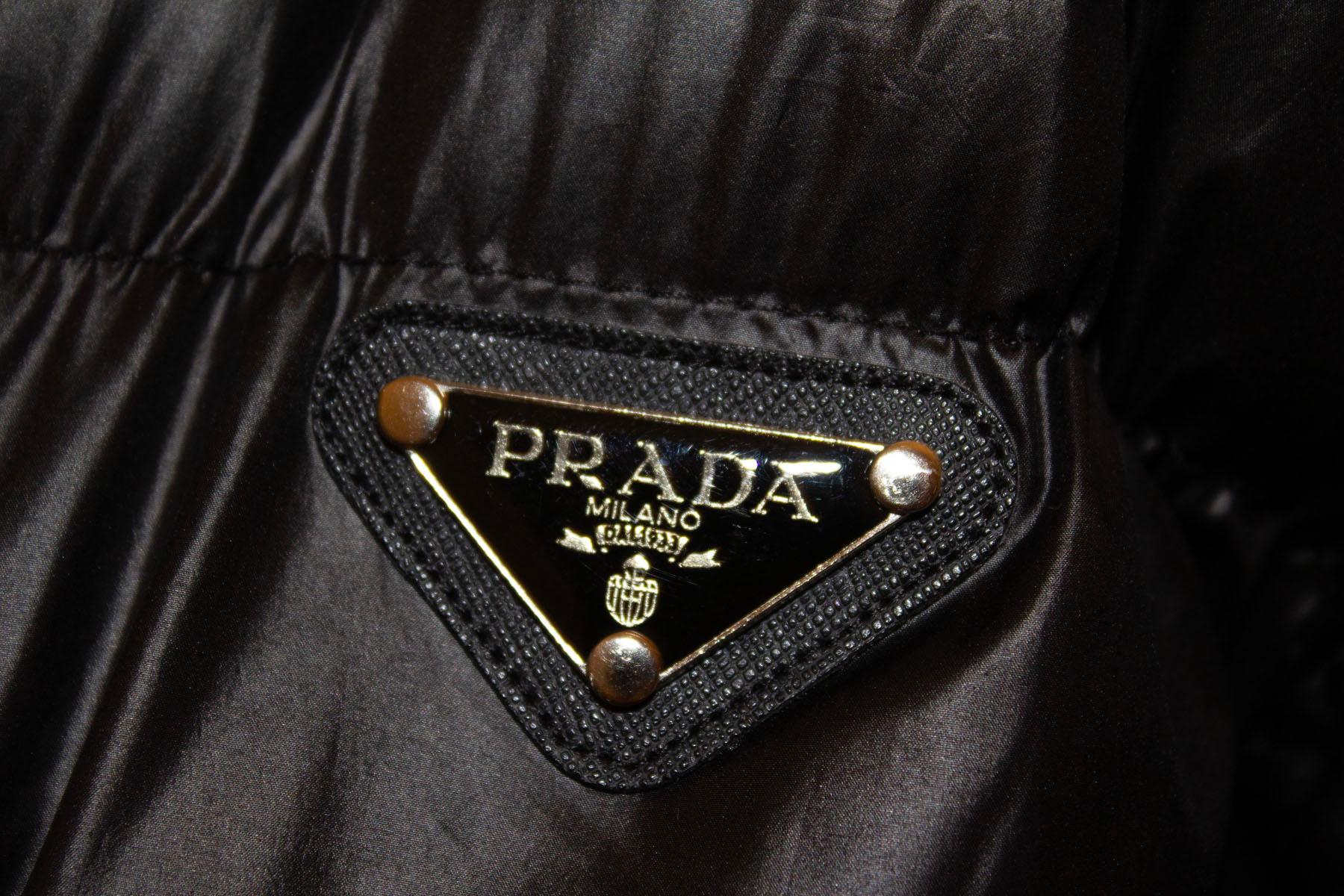 A great black Prada puffa jacket , perfect for Fall /Winter. The jacket is is in excellent condition and has the advantage of having detachable sleaves , and so can be worn as a gilet or jacket. 
The jacket has a central zip opening, and two zip