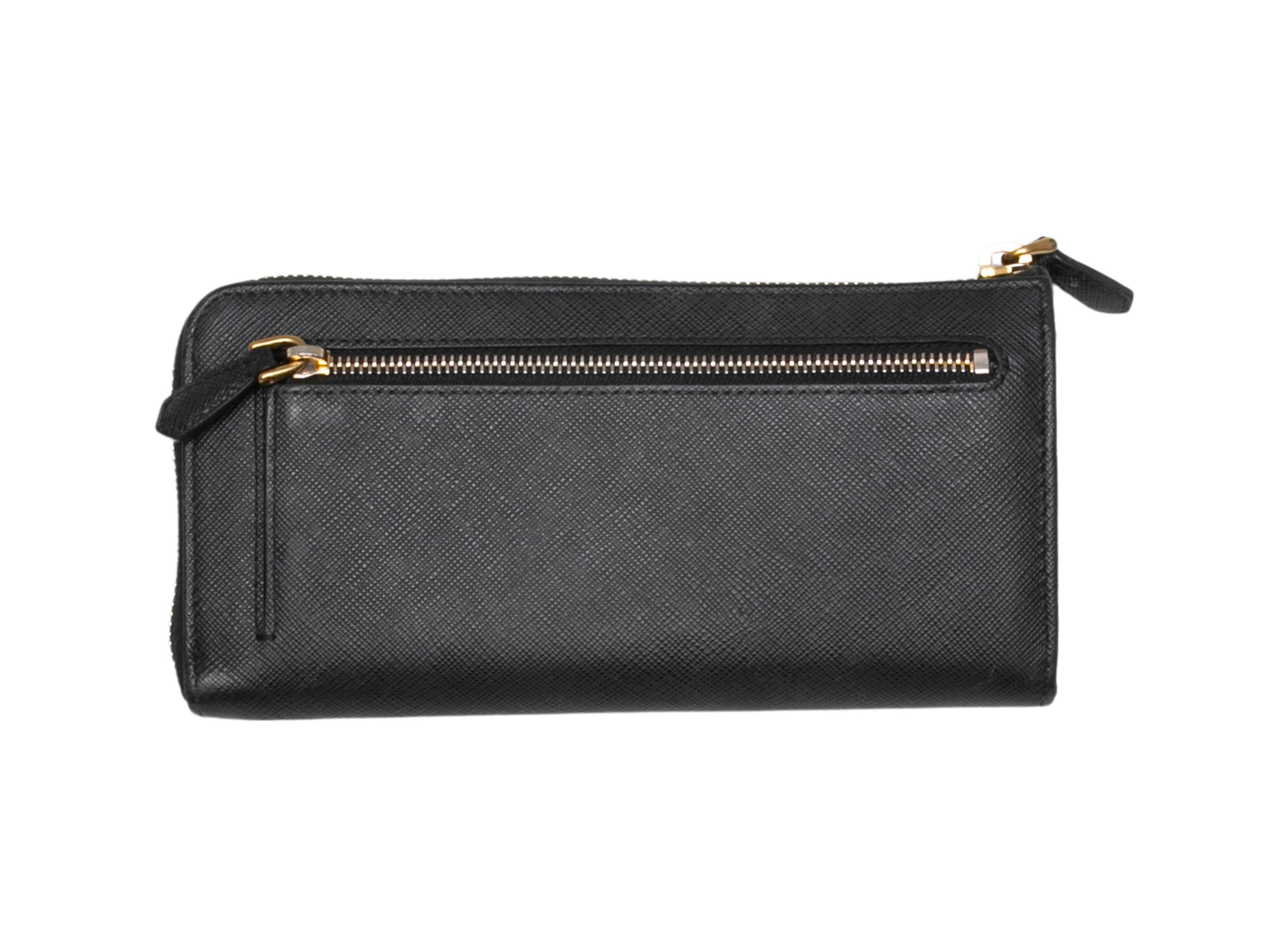  Black Saffiano leather continental zip wallet by Prada. Gold-tone hardware. Exterior back zip pocket. Top zip closure. 4