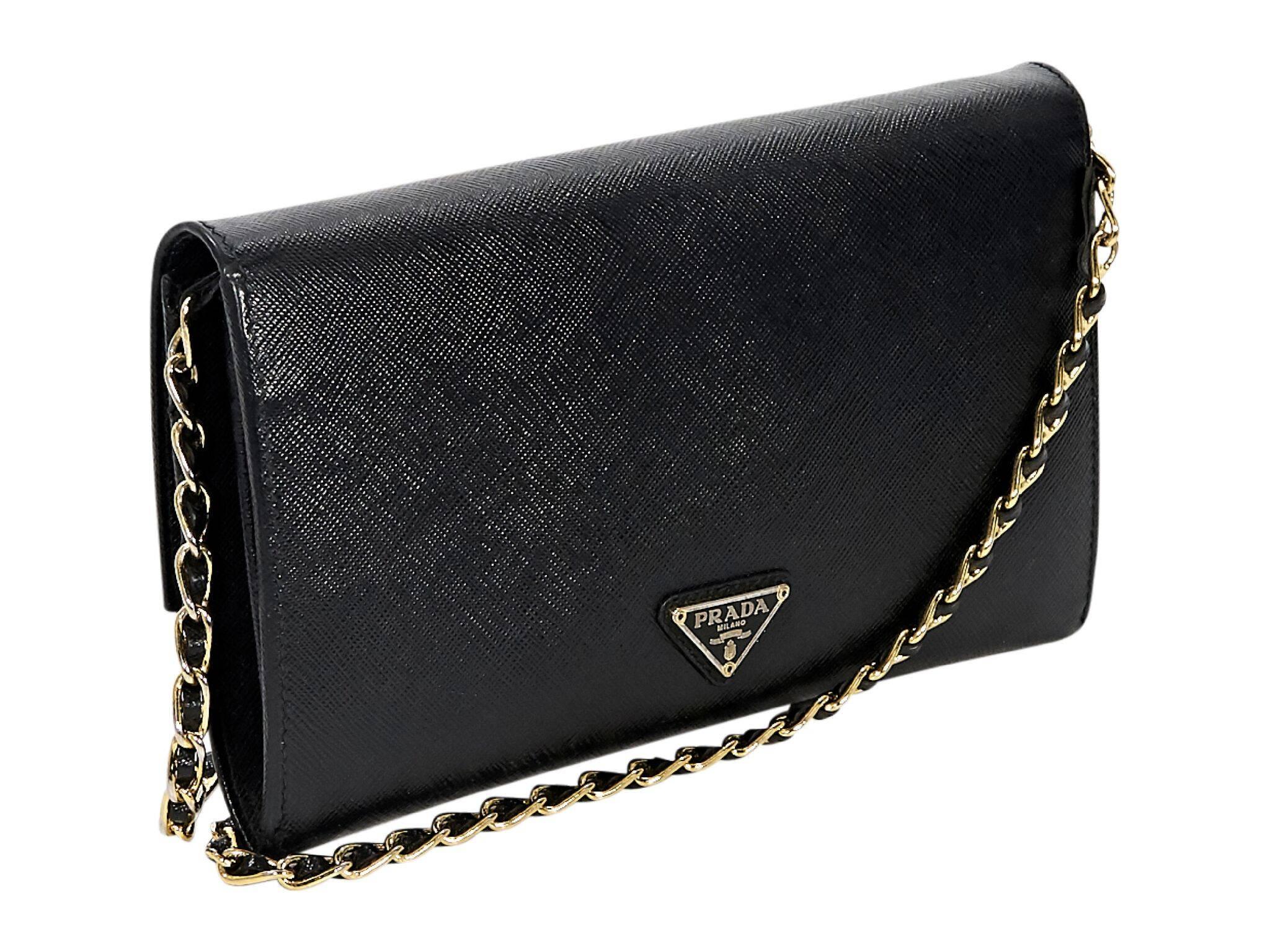 Product details:  Black saffiano leather crossbody bag by Prada.  Detachable chain crossbody strap.  Front flap with twist-lock closure.  Lined interior with inner zip coin pouch, multiple credit card and bill slots.  Goldtone hardware. 9