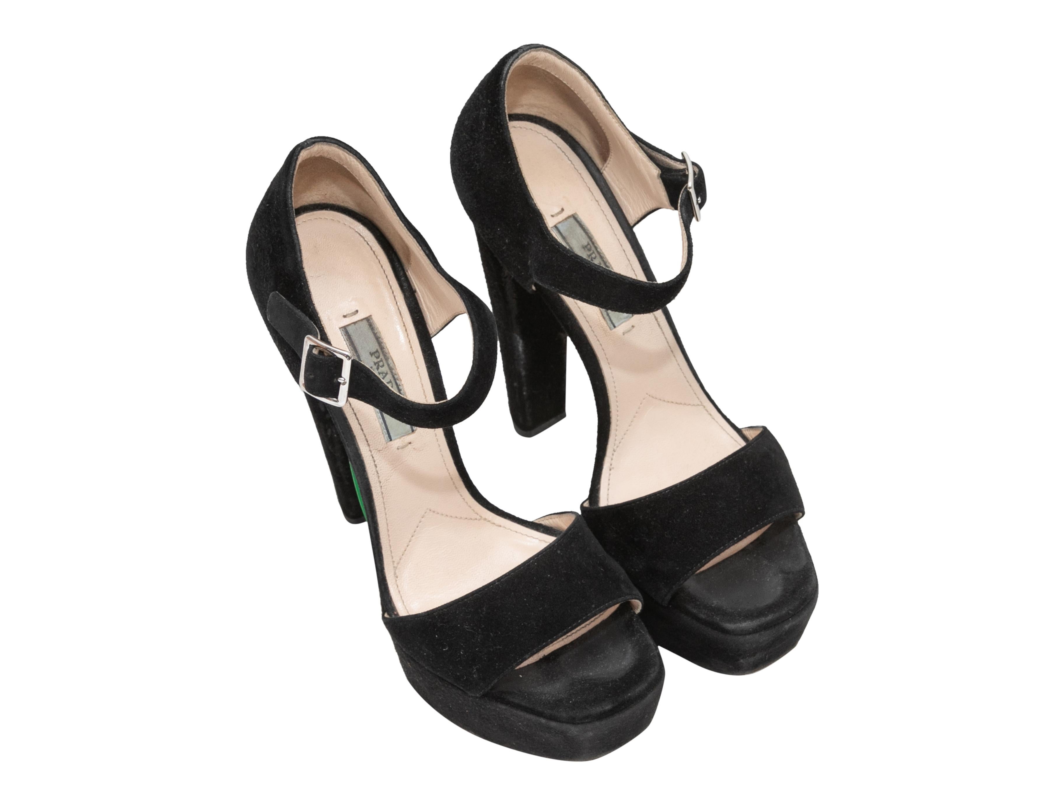 Black suede platform heeled sandals by Prada. Buckle closures at ankle straps. 1.5