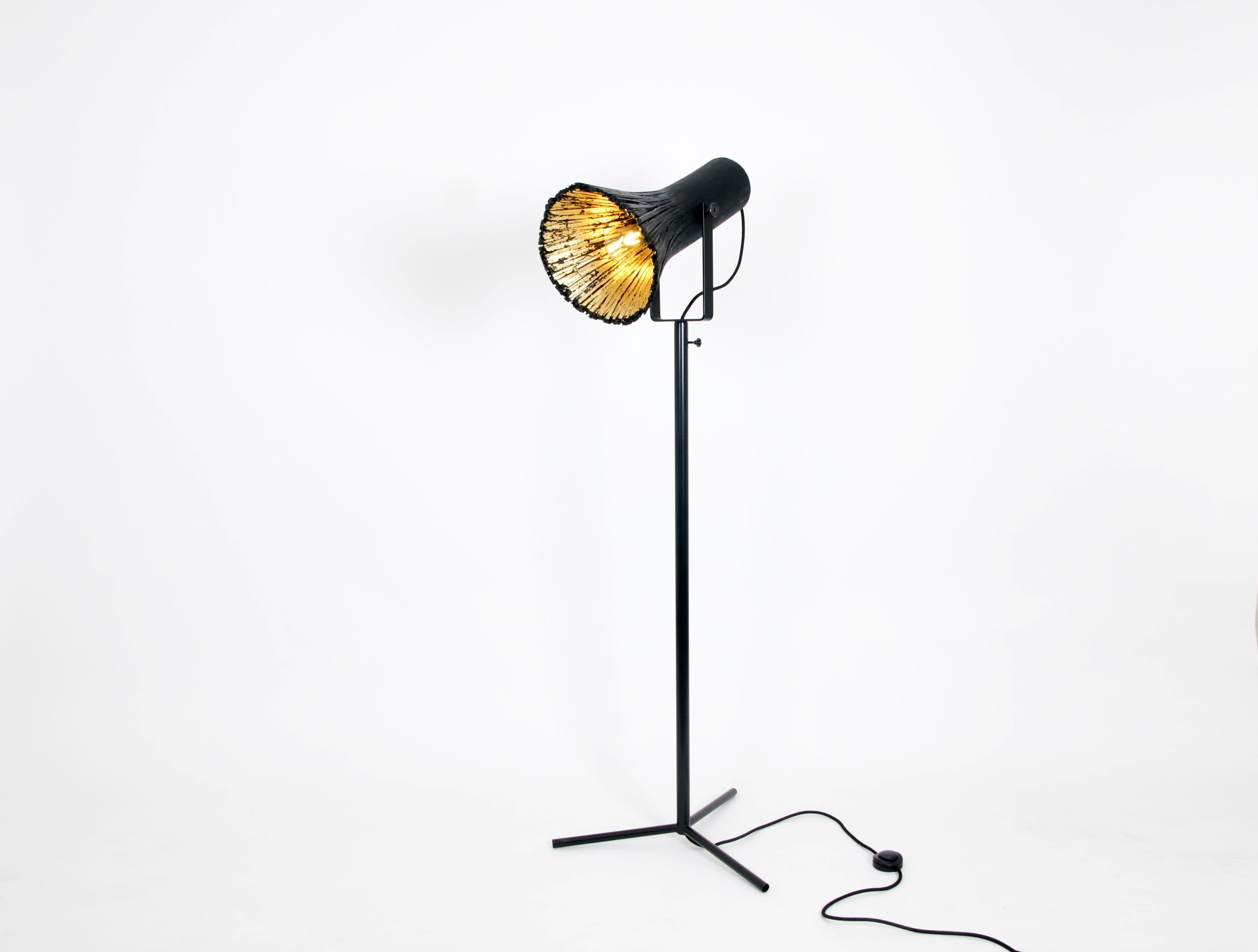 Black pressed wood floor lamp by Johannes Hemann.
Materials: Wood, brass
Dimensions: Height 130cm, Ø 35cm.

The series „pressed wood“ is based on the traditional technique of bentwood, but Johannes Hemann combined it with pressure to get a