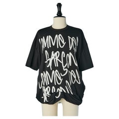Black printed tee-shirt with stiff circle in the bottom edge Comm des Garçons