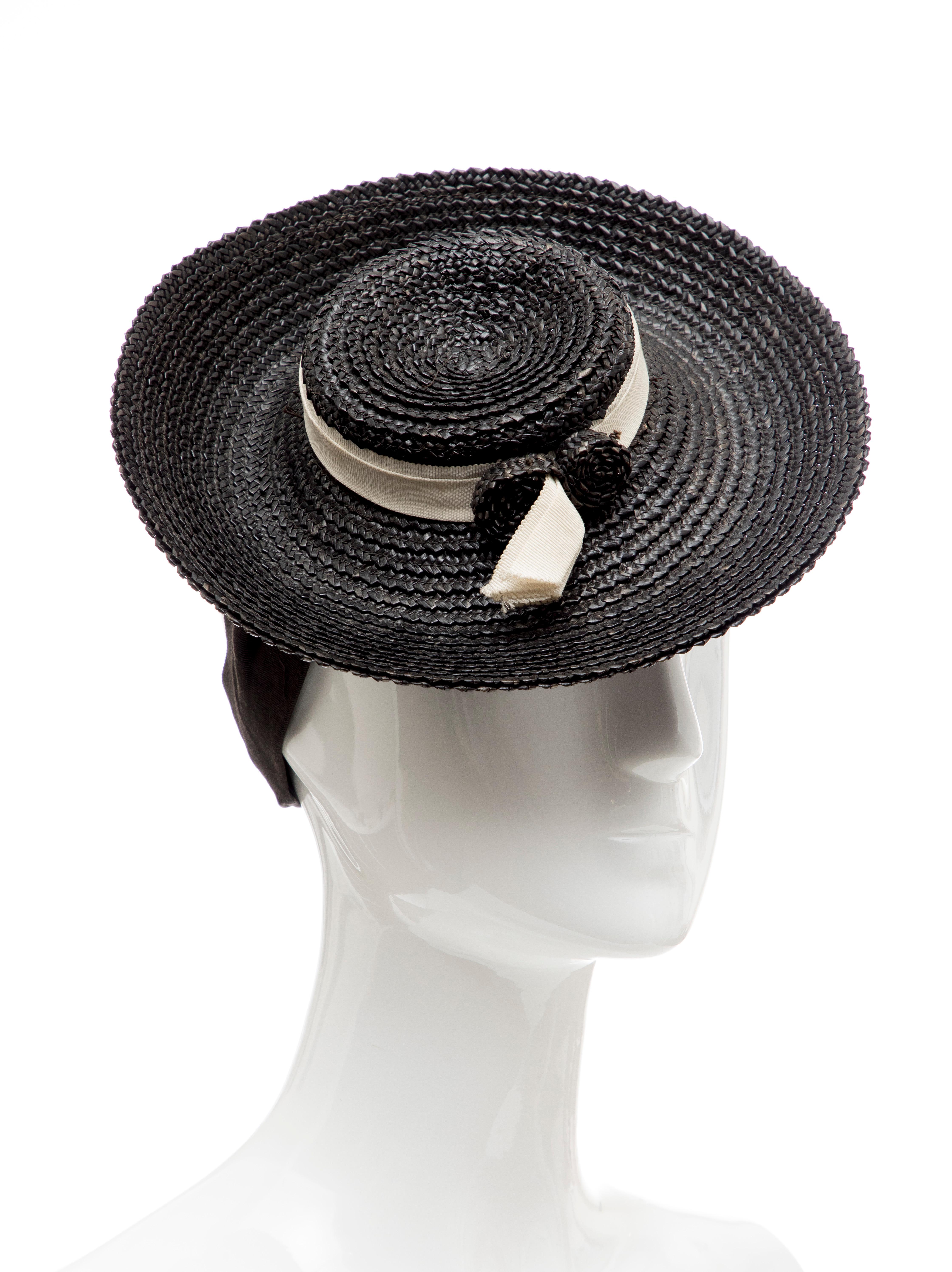 Black raffia tilt hat with cream grosgrain band. Circa: 1930's

Circumference: 11.5