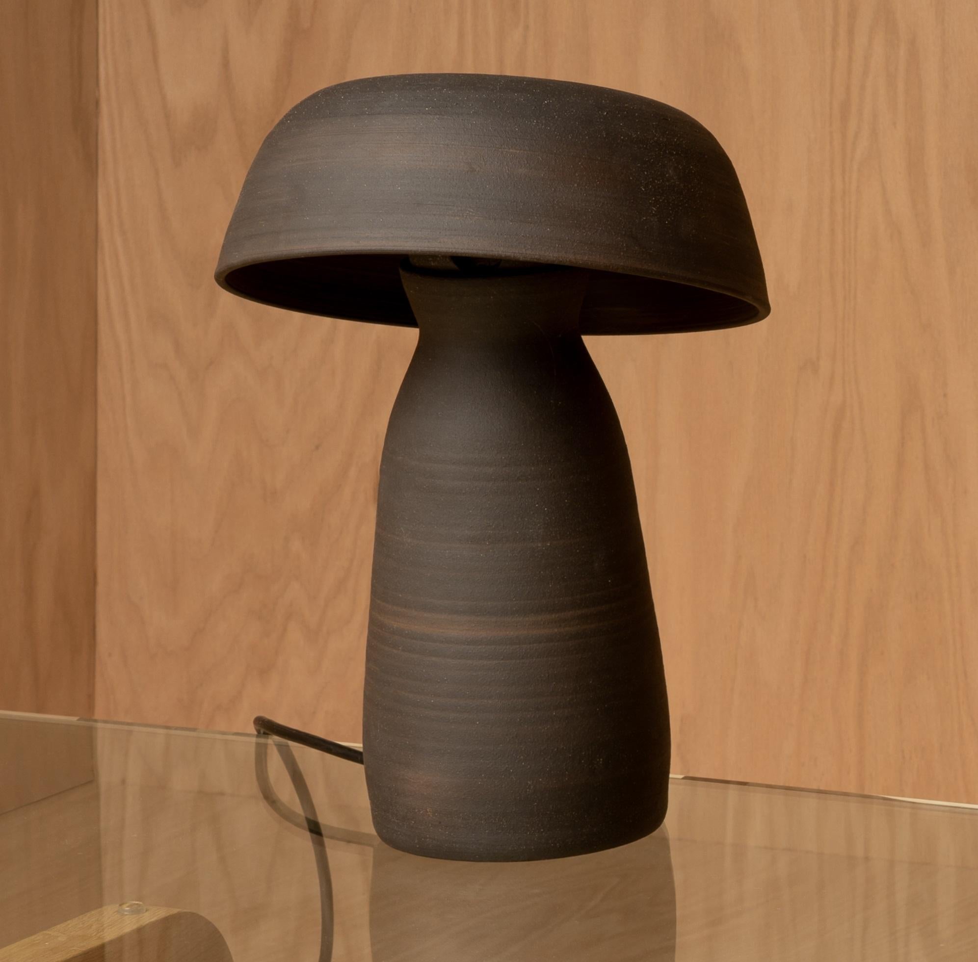 Black Raw Small Mushroom Lamp by Nick Pourfard
Dimensions: Ø 33 x H 38 cm.
Materials: ceramic.
Different finishes available. Please contact us.

All our lamps can be wired according to each country. If sold to the USA it will be wired for the USA