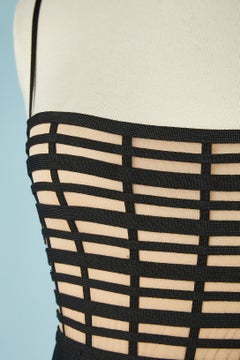 Black rayon jersey band cocktail dress on a nude tulle base Hervé Leger