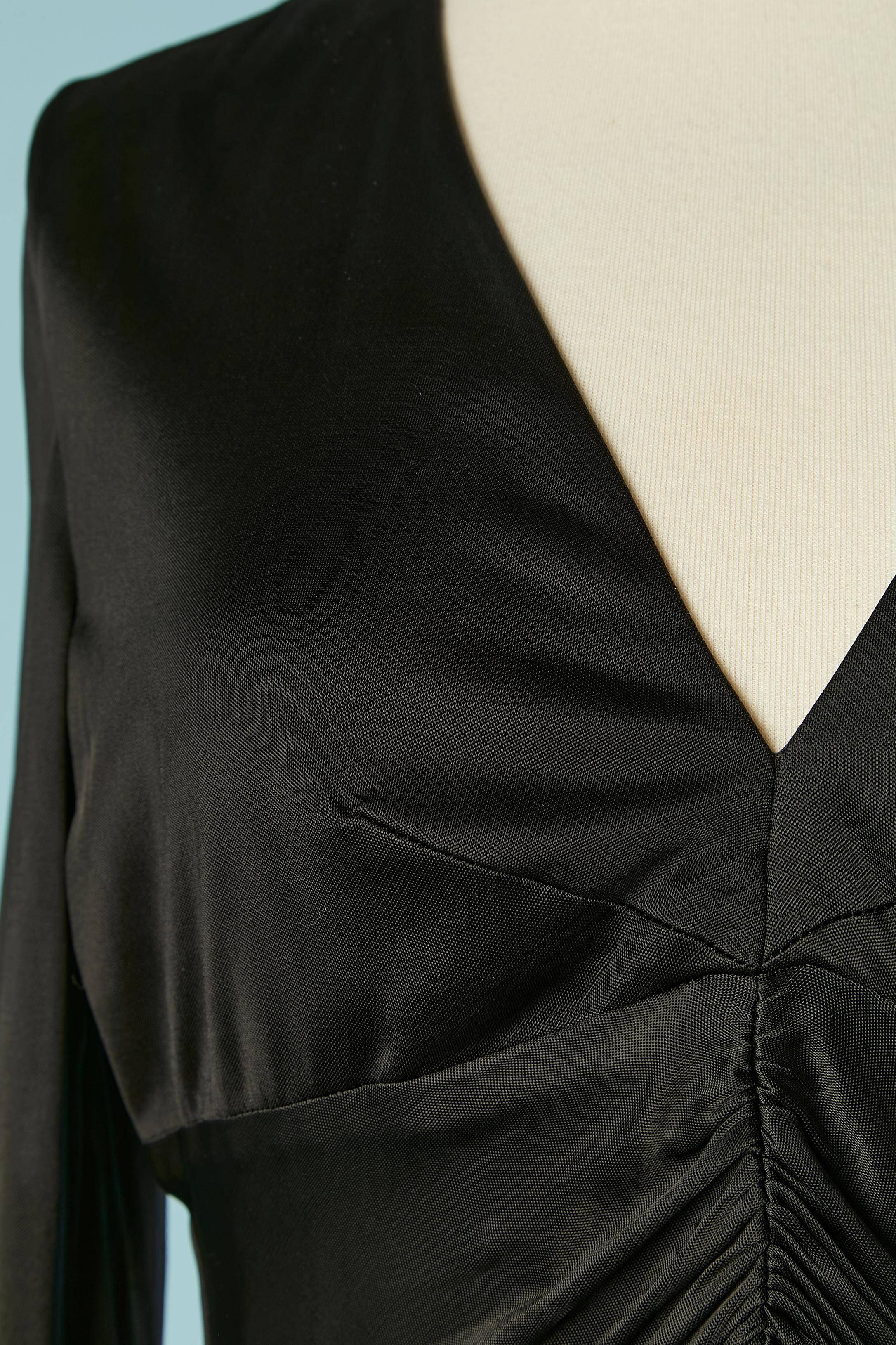 Black rayon jersey cocktail dress draped on the front. Jersey lining. 
Zip closure middle back. 
SIZE 44 (It) 40 (Fr) M 