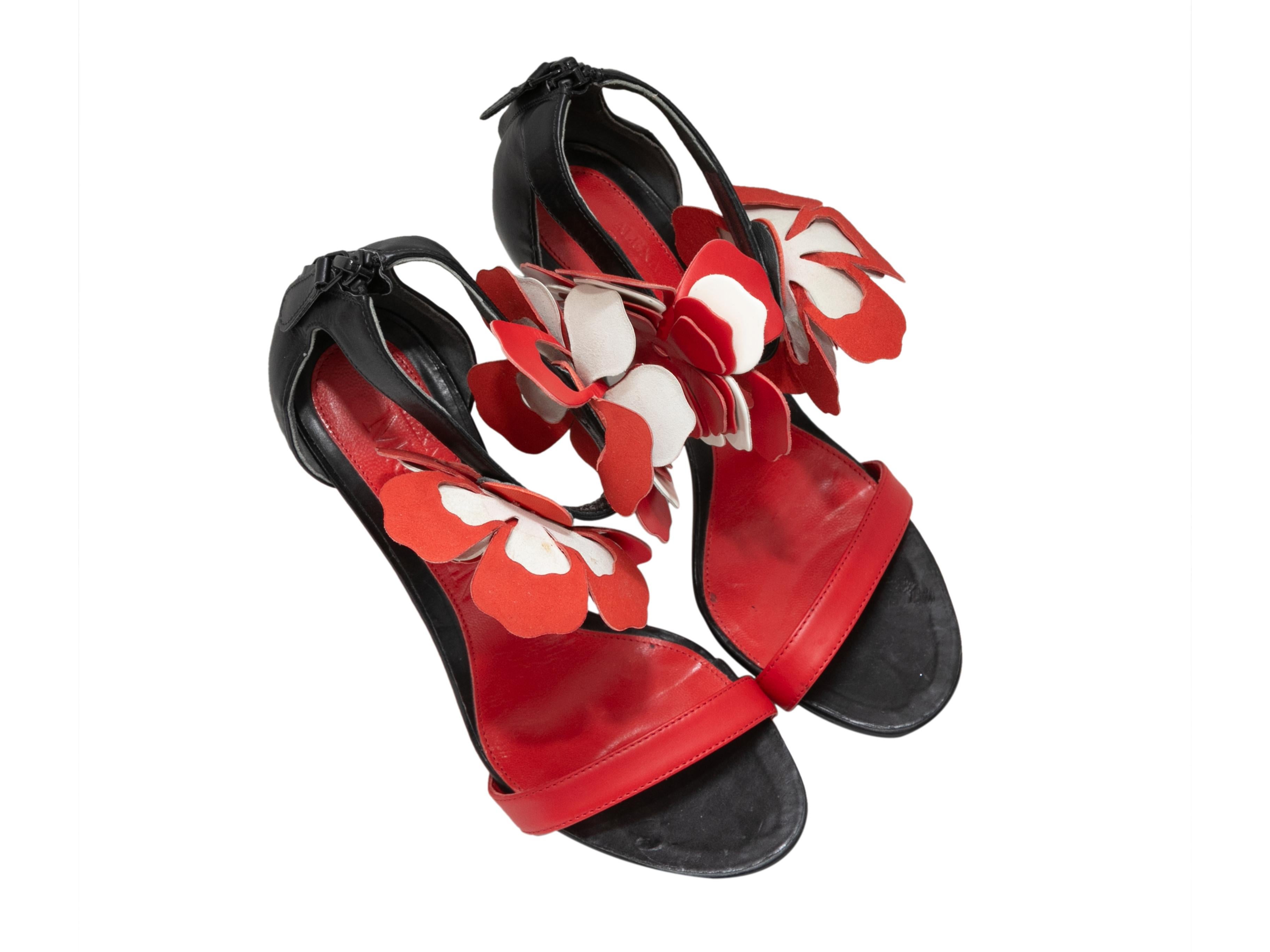 Black and red leather ankle strap heeled sandals by Alexander McQueen. Leather flower embellishments at ankle straps. Zip closures at counters. 5