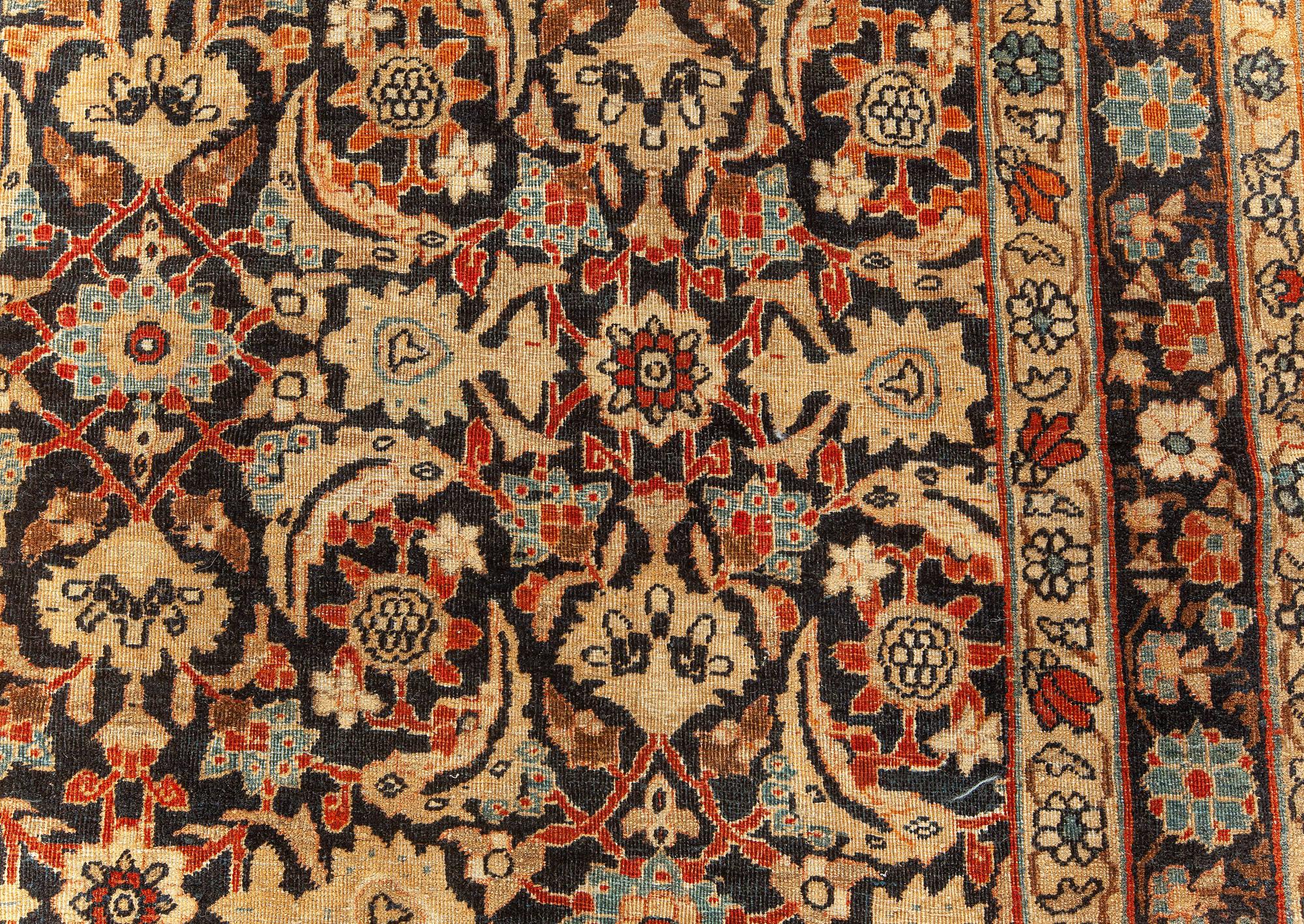 Antique Kirman Rug in Black, Red and Yellow
Size: 12'7