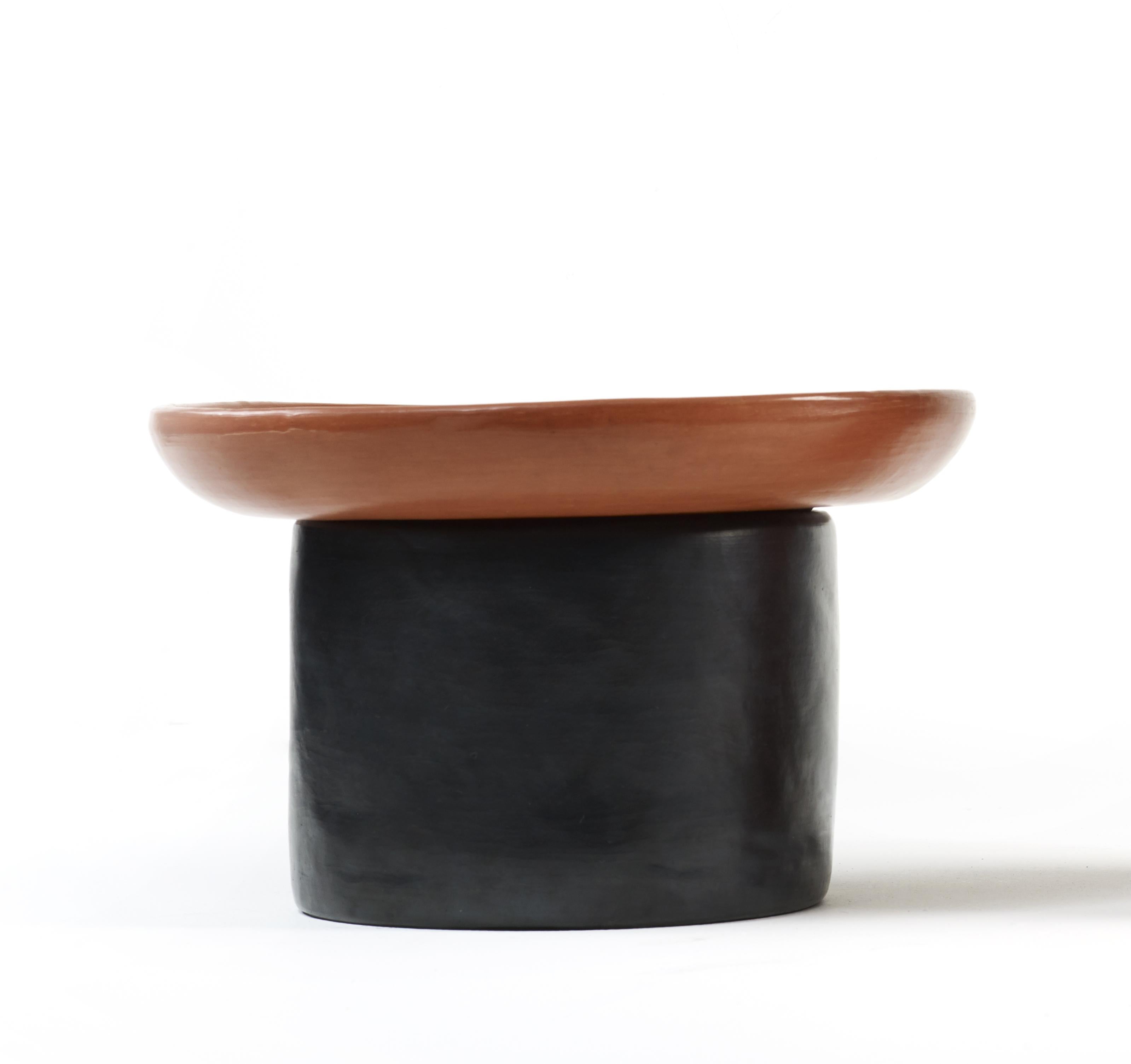 Black/red small nuna side table by Sebastian Herkner
Materials: Heat-resistant black and red ceramic. 
Technique: Glazed. Oven cooked and polished with semi-precious stones.
Dimensions: Diameter 42 cm x height 23 cm 
Available in colors red, and