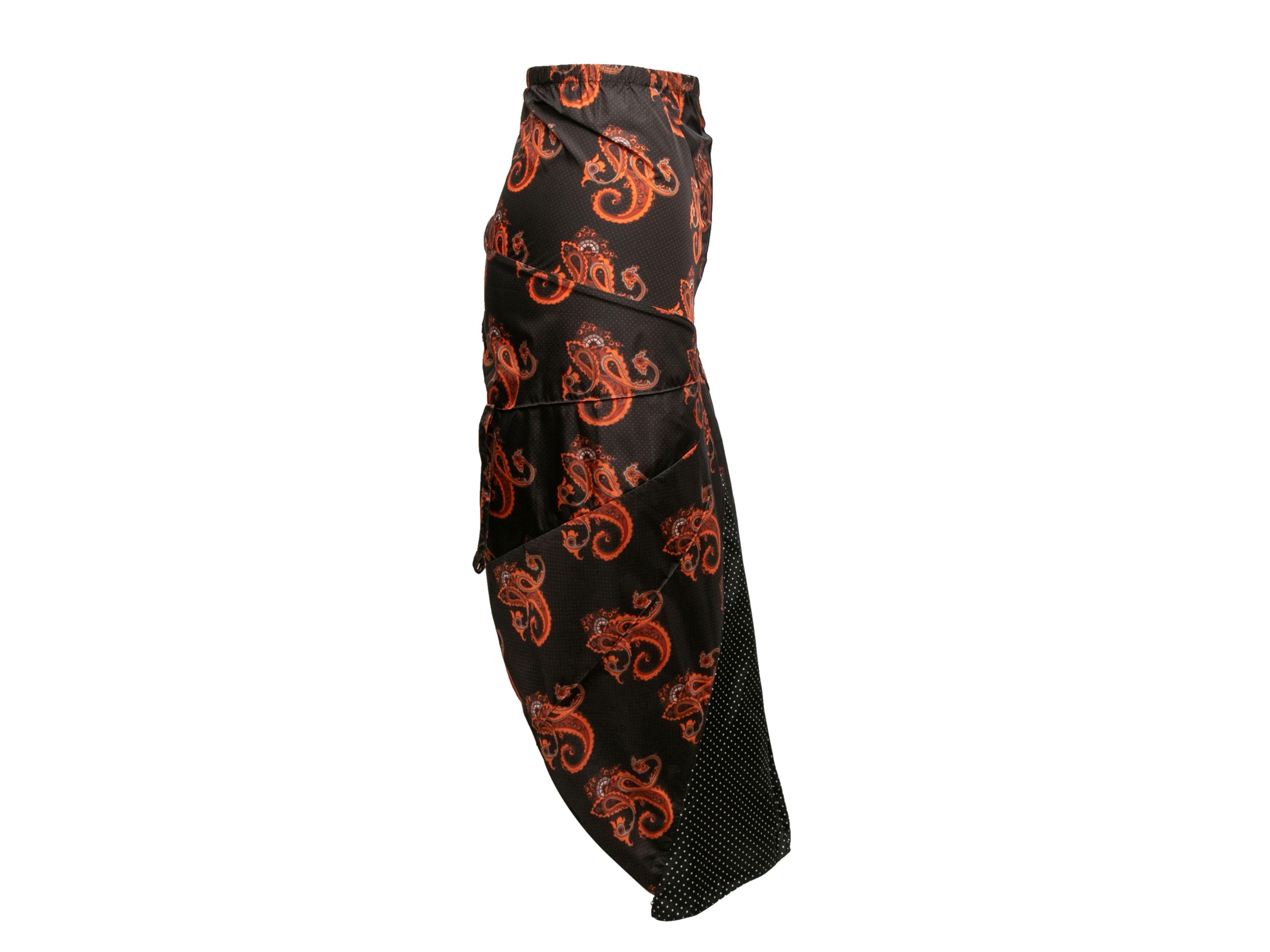 Black and red paisley and polka dot print knee-length nylon skirt by Vetements. Pleated panel at front. Zip closure at back. 24
