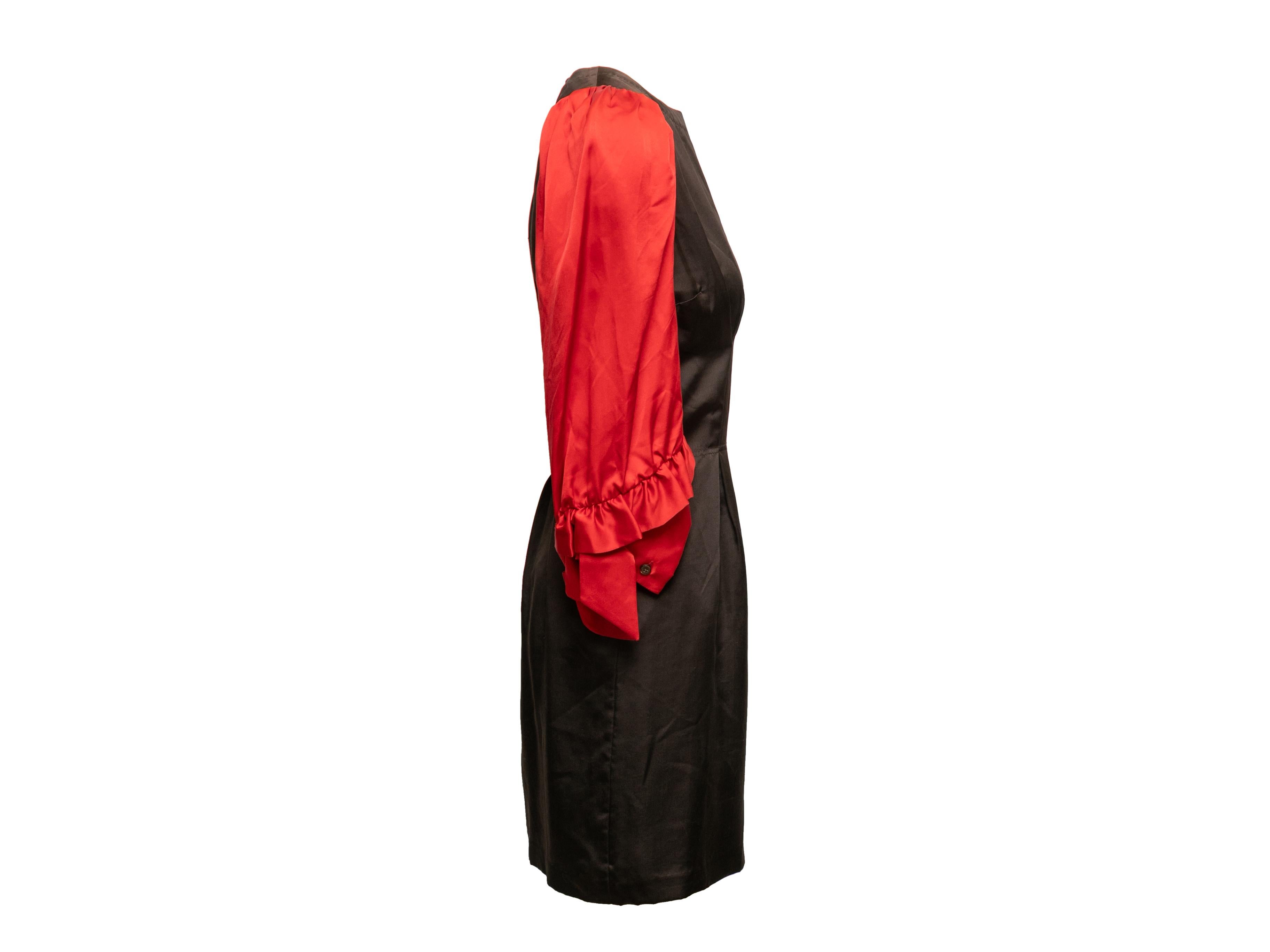 Product Details: Black and red silk color block dress by Viktor & Rolf. Crew neck. Long sleeves featuring ruffle trim. Zip closure at back. 34