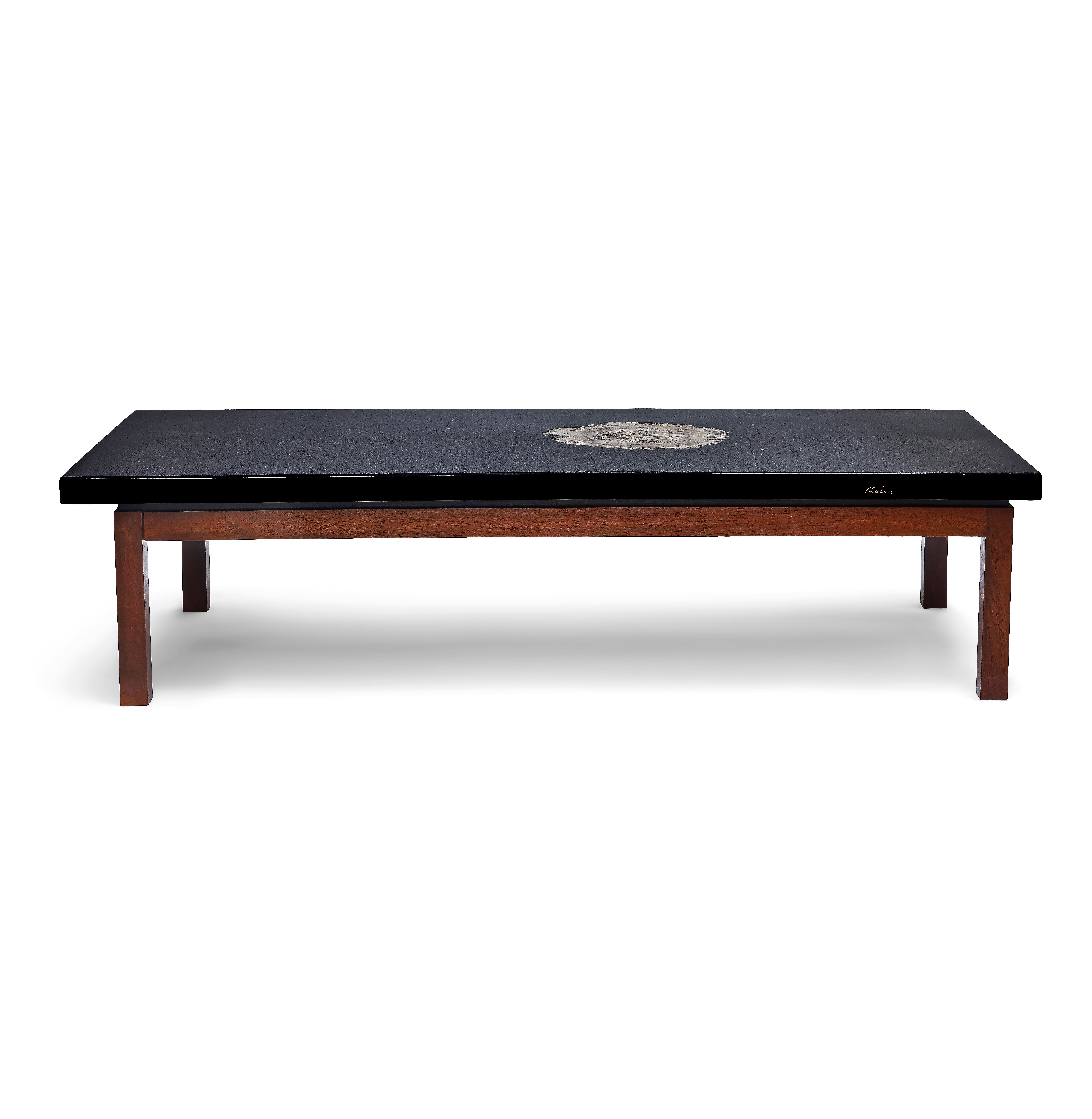 Black resin coffee table sitting on a wooden base with inset agate, designed by Ado Chale. Signed 'Chale' to the front with a ruby.
Ado Chale is a celebrated Belgian artist and designer known for his exquisite inlays in petrified wood, minerals or