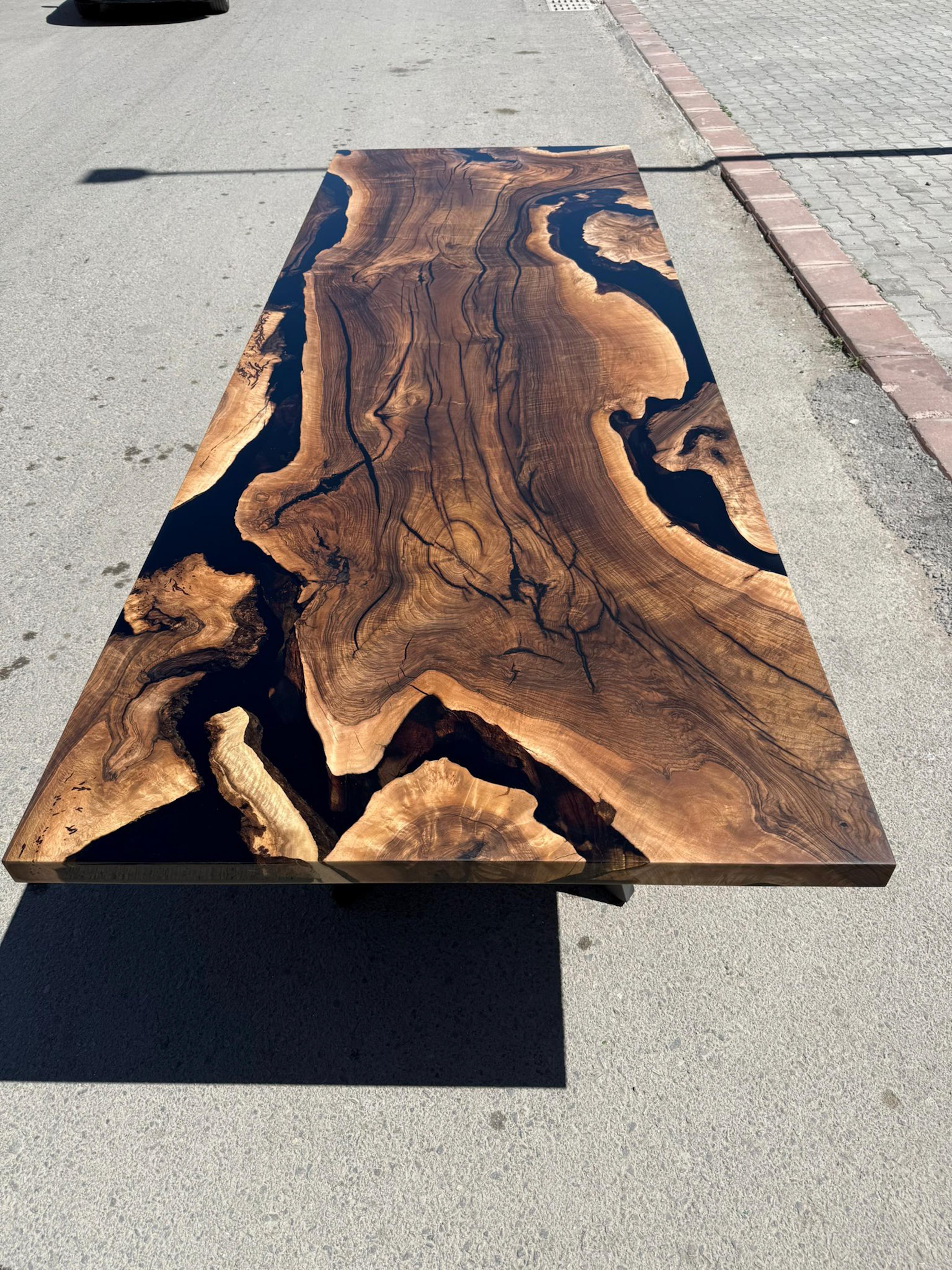 Walnut Wood Live Edge Clear Epoxy Resin Kitchen & Dining Table 

This table is made of 500 years old Walnut Wood. The grains and texture of the wood describe what a natural walnut woods looks like.
It can be used as a dining table or as a conference