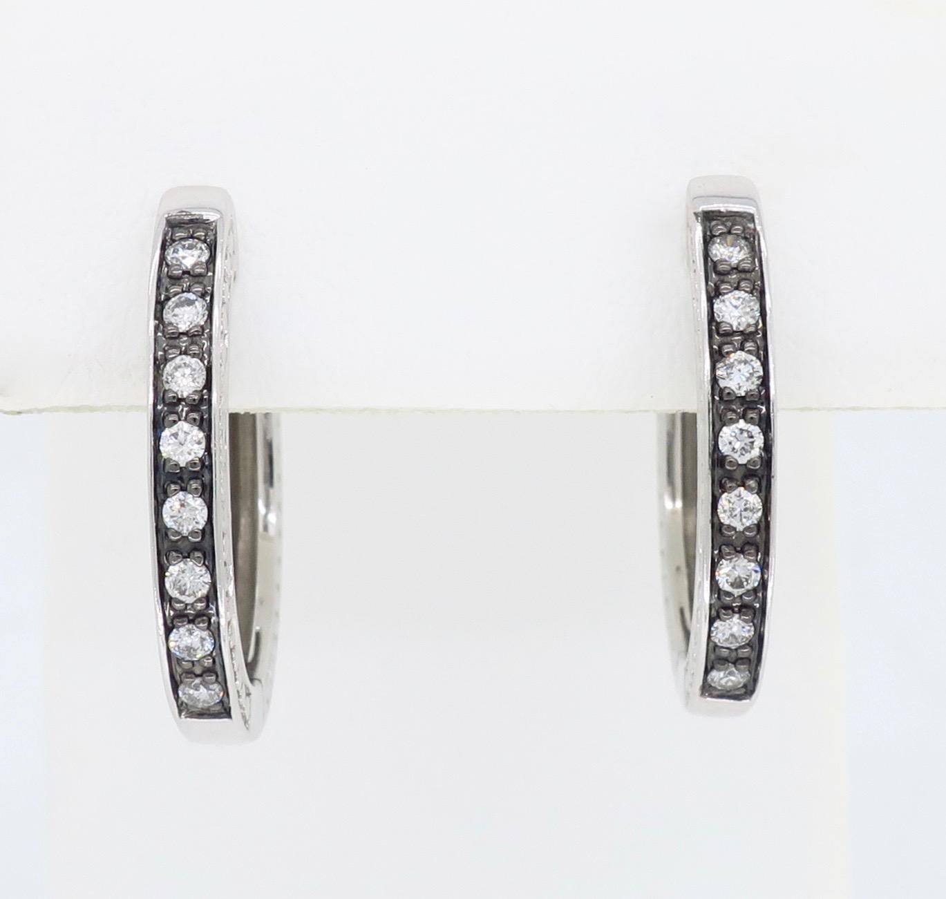 These stunning oval hoop earrings feature .25CTW of Round Brilliant Cut Diamonds set in 14K white gold.

Diamond Carat Weight: .25CTW
Diamond Cut: 16 Round Brilliant Cut Diamonds
Color: Average G-I
Clarity: Average SI
Metal: 14K White