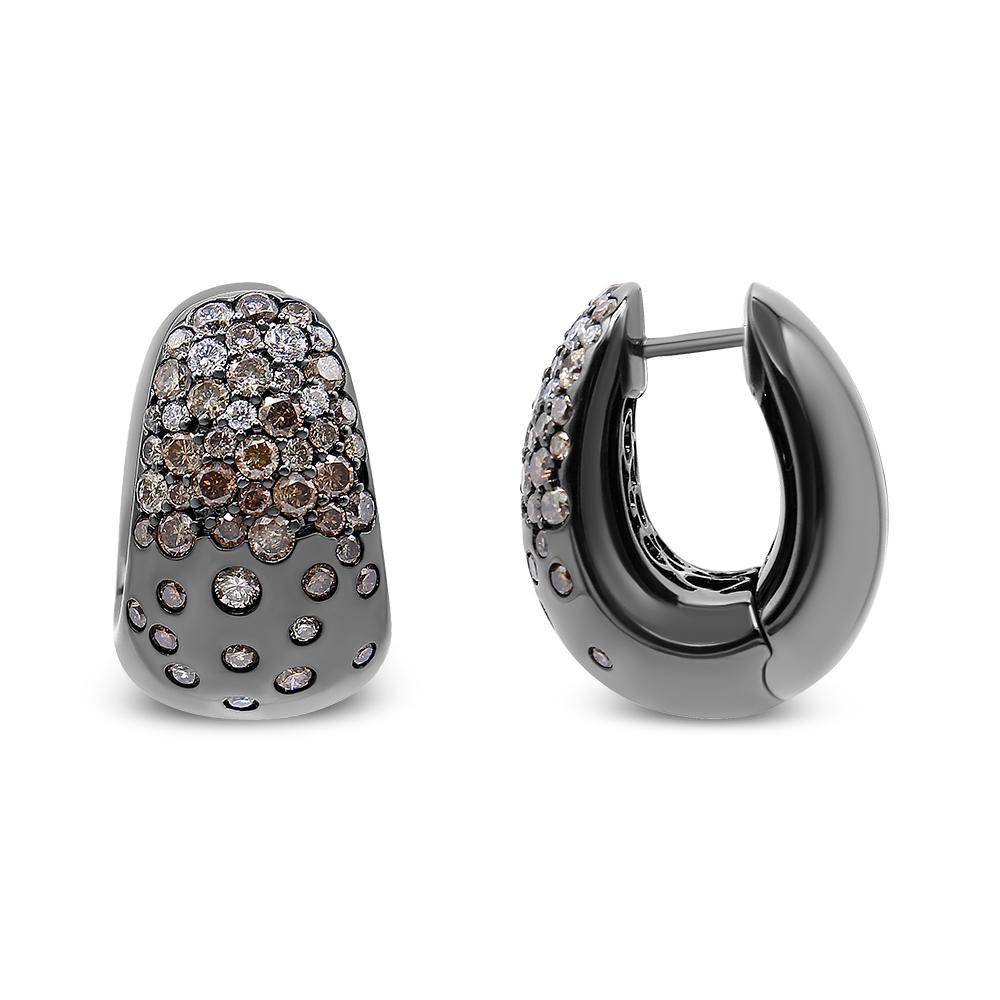 Step your earring game up a notch by with this unique take on the diamond huggie hoop style. This pair of huggie hoop earrings features 18K White Gold with a layer of black rhodium; instantly making these earrings stick out from the rest. But we