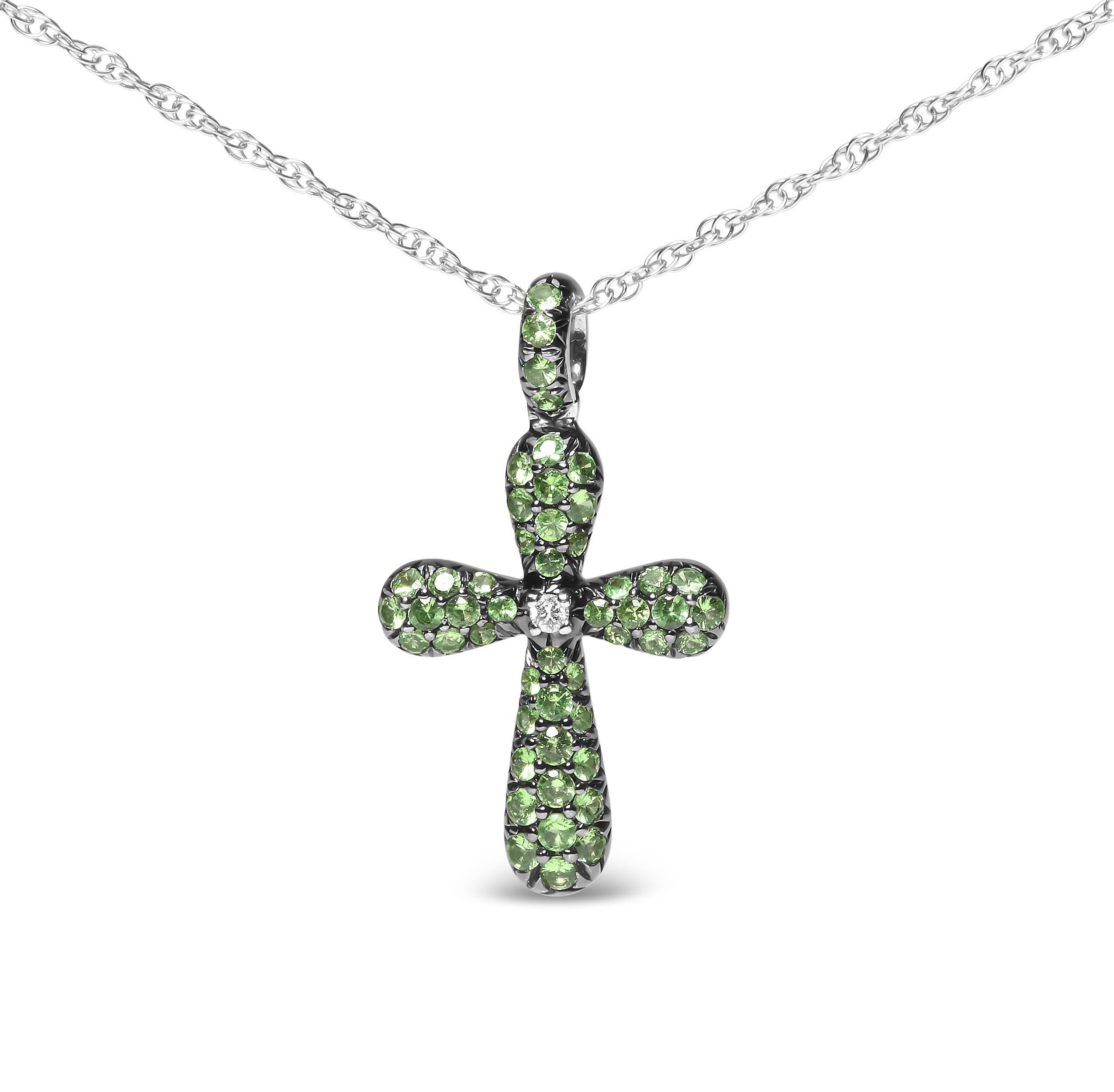 Give your ensembles a distinctive look by adding this faith-statement cross pendant necklace made of black rhodium plated 18k white gold. The cross silhouette is comprised of natural 1.6 x 1.6mm round heat-treated green tsavorite gemstones,