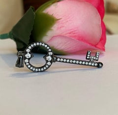 Black rhodium-plated solid 18 kt gold diamond key pendant