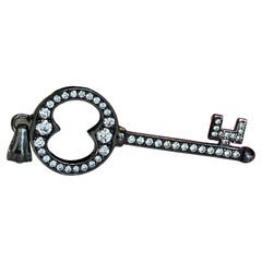 Black rhodium-plated 18 kt gold diamond key pendant