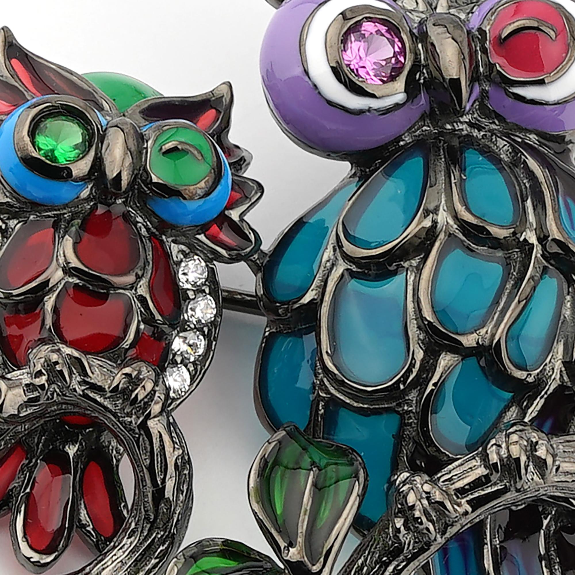 Black rhodium plated 925 sterling silver with enamels Owls shaped brooch. Elegant brooch made in 925 sterling silve plated with black rhodium and embellished with synthetic pink corundum stone and white zirconia depicting two owls on a branch . All