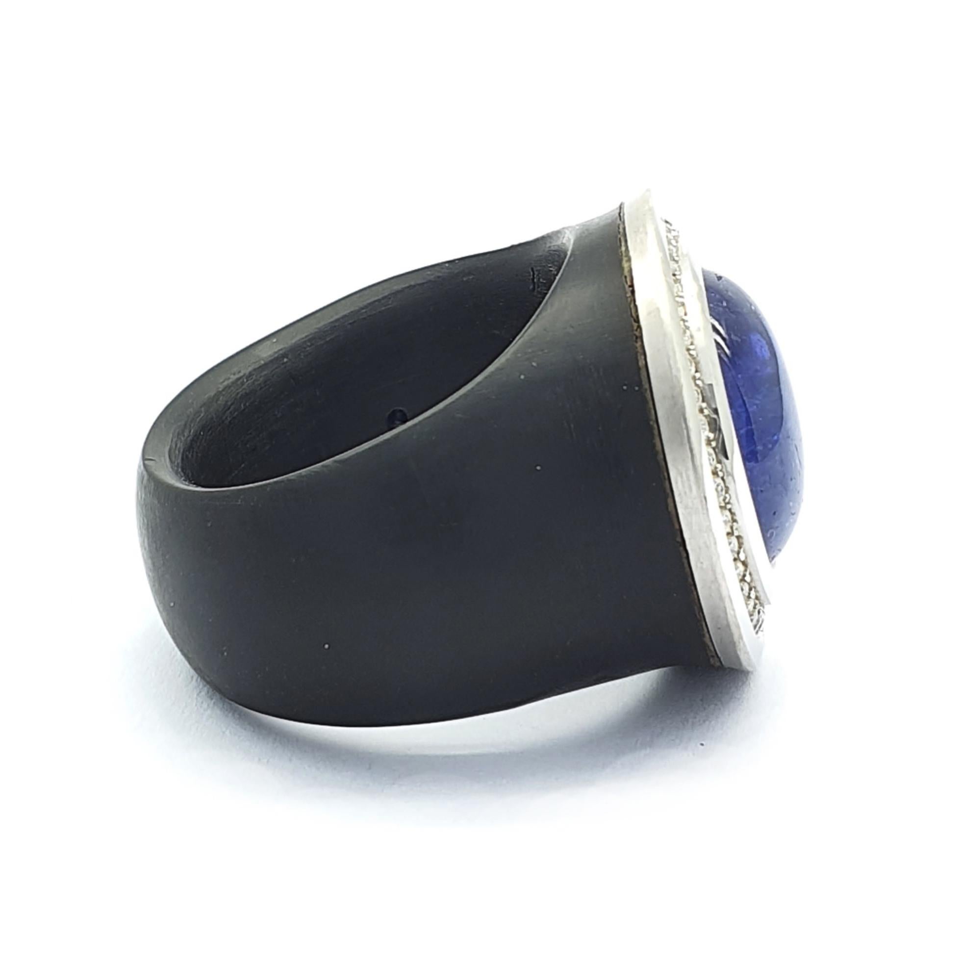 Round Cut Black Ring with a Cabochon Tanzanite of 12.08 Carat and 36 H&A cut Diamonds For Sale