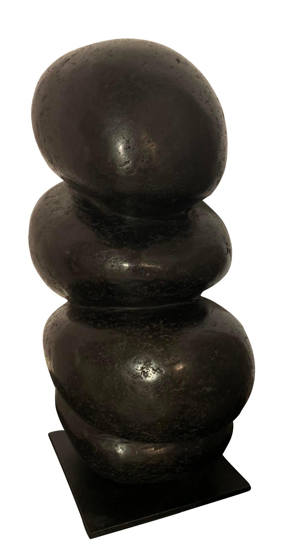 Contemporary Indonesian rock sculpture from river stone.
Four smooth and polished finish stones joined to form decorative sculpture.
Mounted on iron stand measures 7