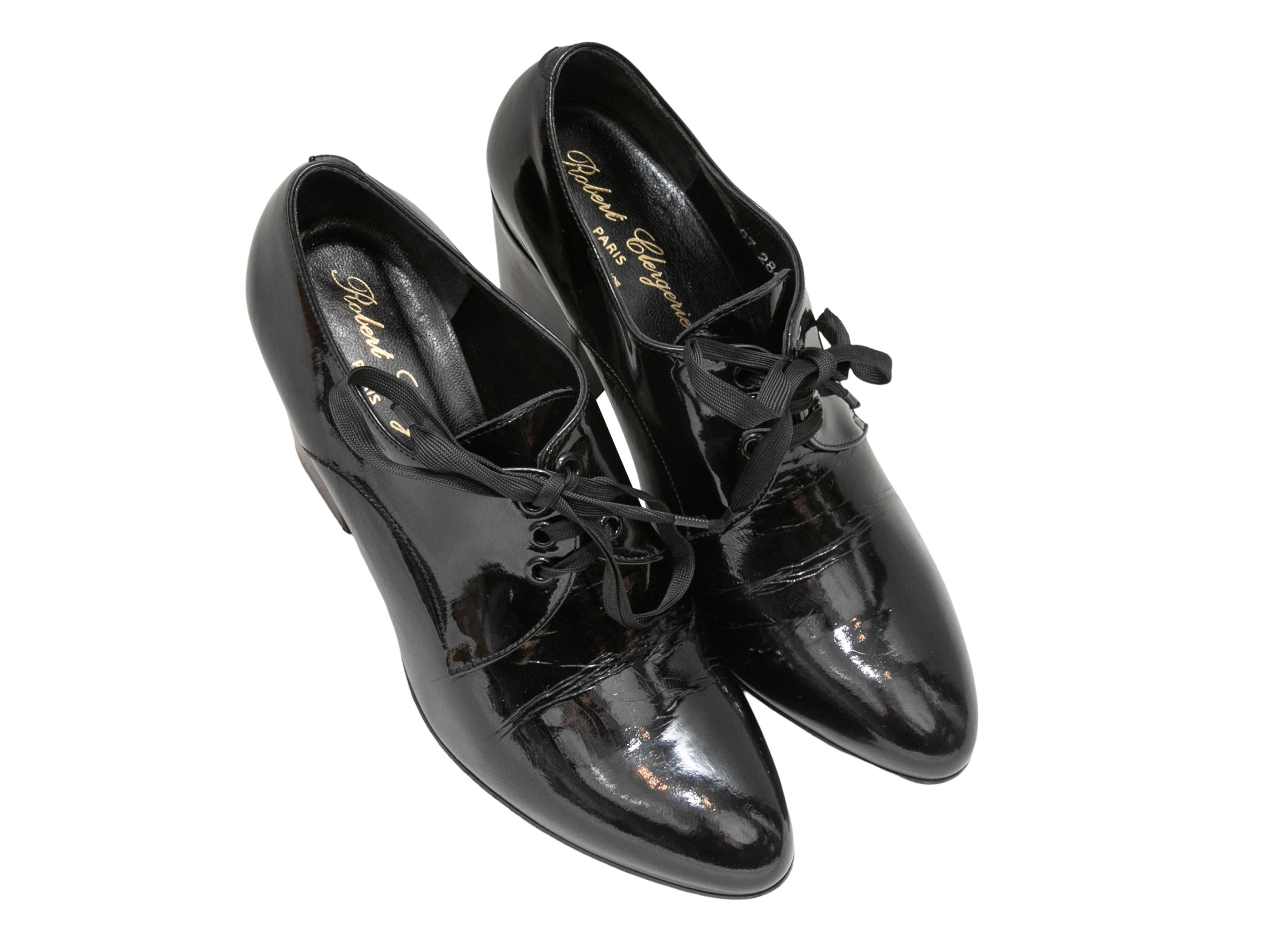 Black pointed-toe patent leather oxford pumps by Robert Clergerie. Block heels. Lace-up tie closures at tops. 2.5