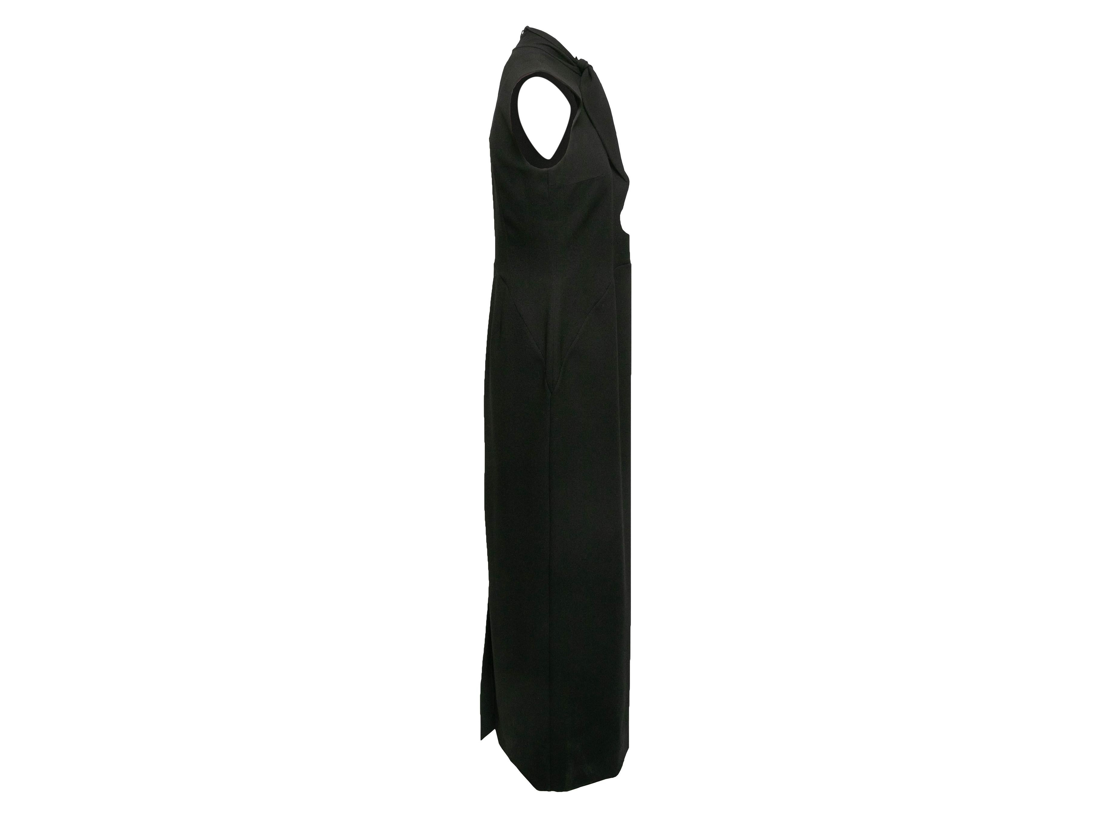 Black cutout Kamaria sleeveless dress by Roksanda. Tie accent at front neckline. Zip closure at back. 34