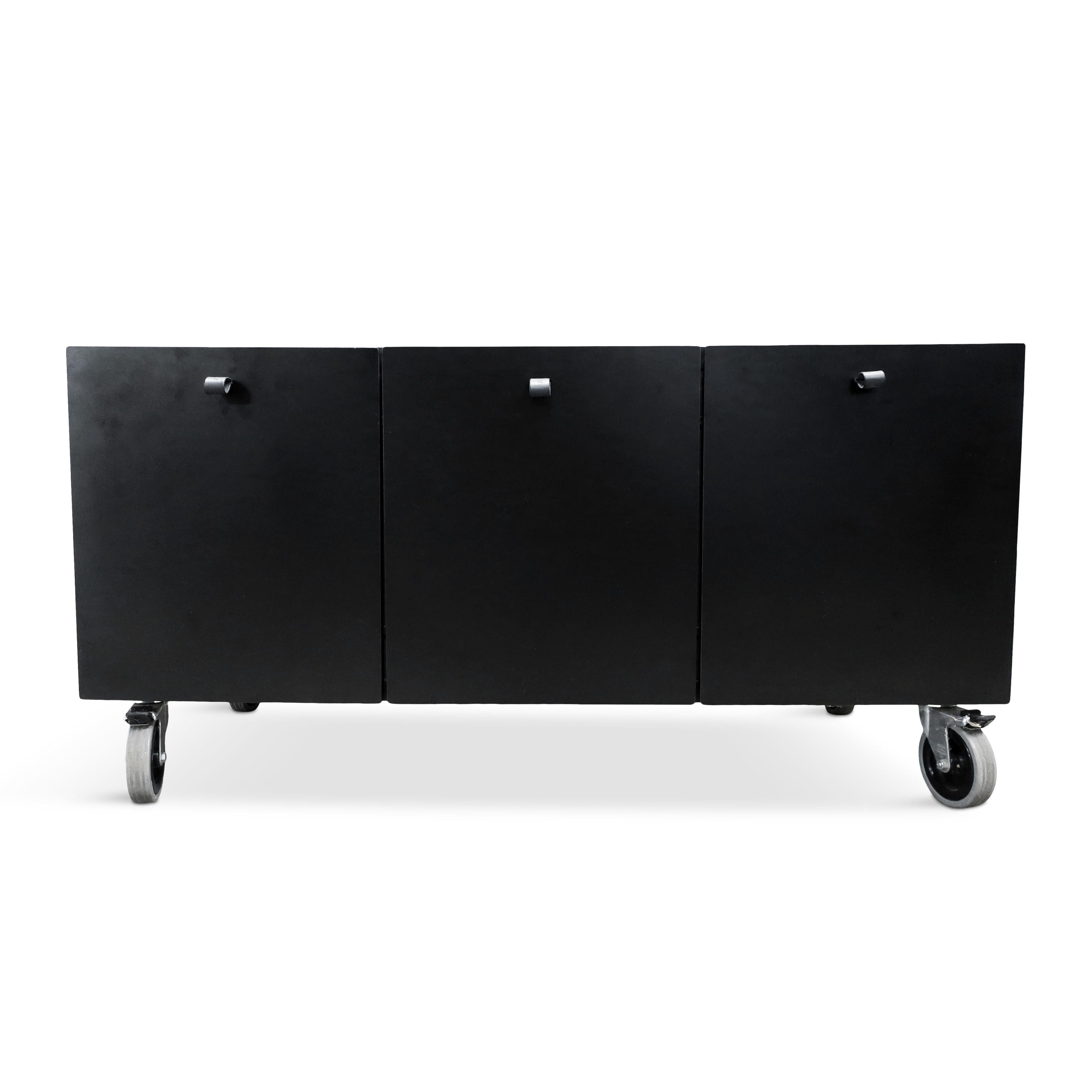 A well-designed rolling storage cabinet or credenza by Bulo, the Belgian furniture maker. A simple rectangular case with three storage areas, open on the left and right with a hanging file drawer in the middle. Very cool BULO embossed pulls on the