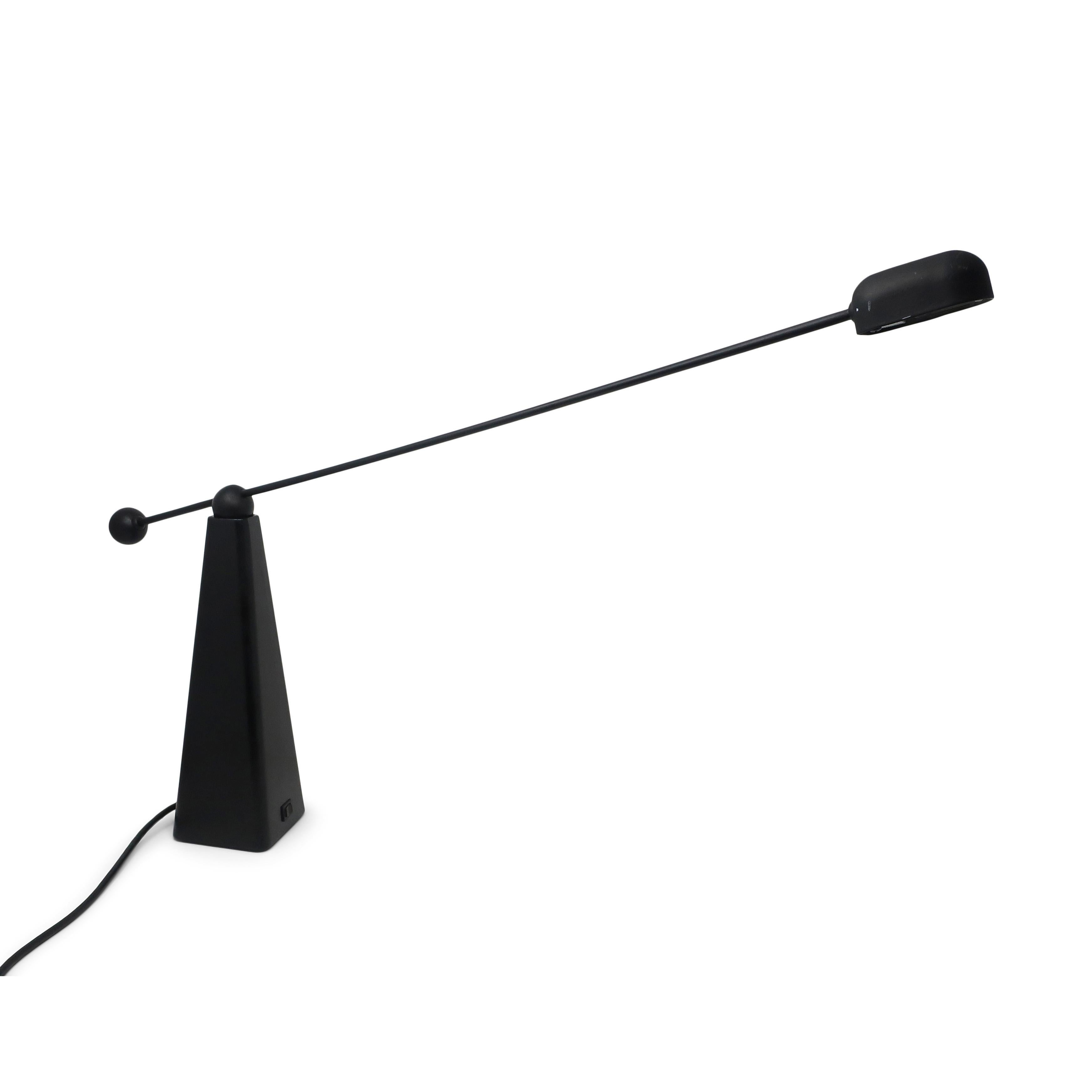 Designed in 1982 by Ron Rezek for Artemide, the Orbis halogen lamp is a fantastic example of 1980s postmodern and minimalist design. The counter-balanced black enameled arm pivots freely on a black cast metal base. 

In very good vintage and