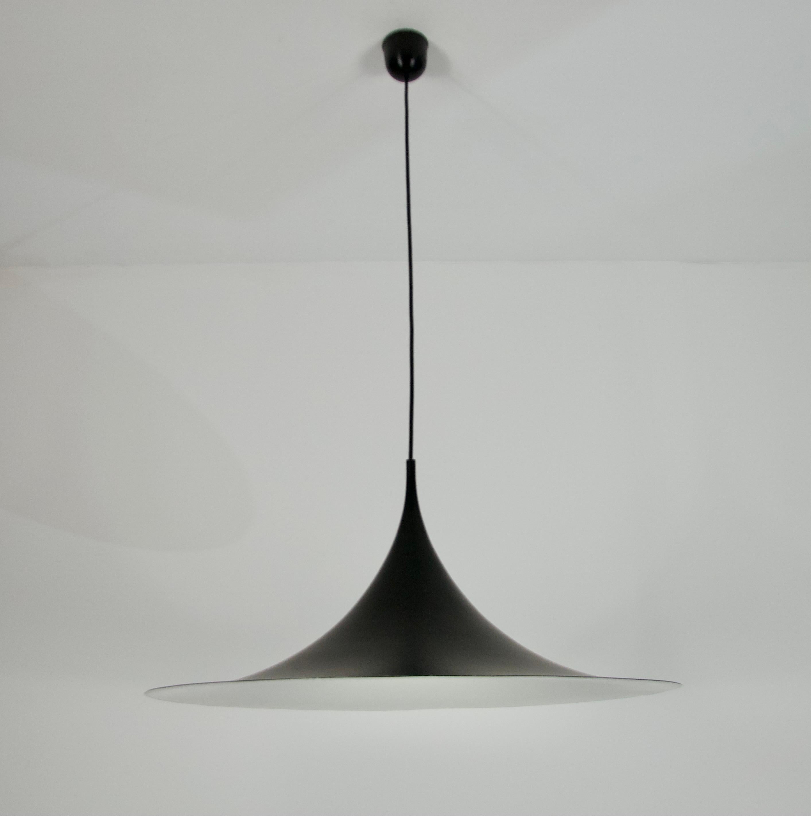 Diese Designer-Deckenleuchte von Fog & Mørup ist ein elegantes Stück aus dünnem Aluminium mit schwarzer Beschichtung, das die Form eines Hutes hat. Mit ihrem schwarzen Baldachin verkörpert diese Lampe die unverwechselbare Ästhetik des Space Age.