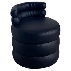 Black rounded puff lounge chair, sculptural and contemporary low seat
