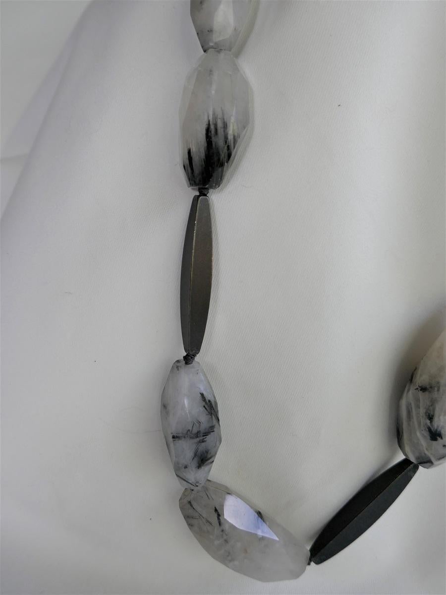 This necklace look great on. Definitely a statement piece. Neutral and goes with a lot of color tones. This necklace combines Black Rutilated Quartz nuggets with graphite wands. The nuggets are 12mm-20mm - 32mm- 58mm and the graphite wands 48mm. 