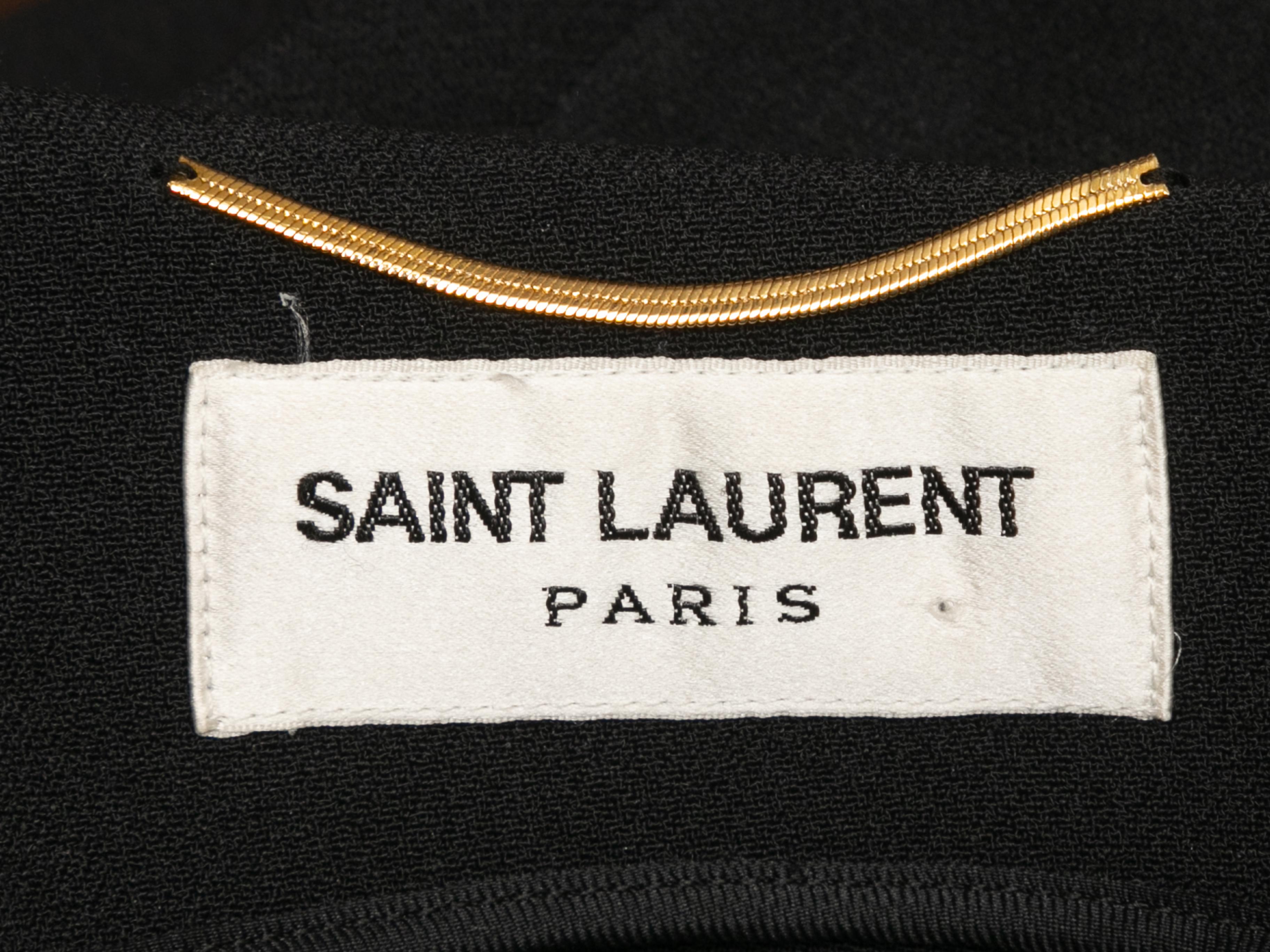 Black long sleeve mini dress by Saint Laurent. Mesh panel accent at front bodice. Leather waist detail. 30