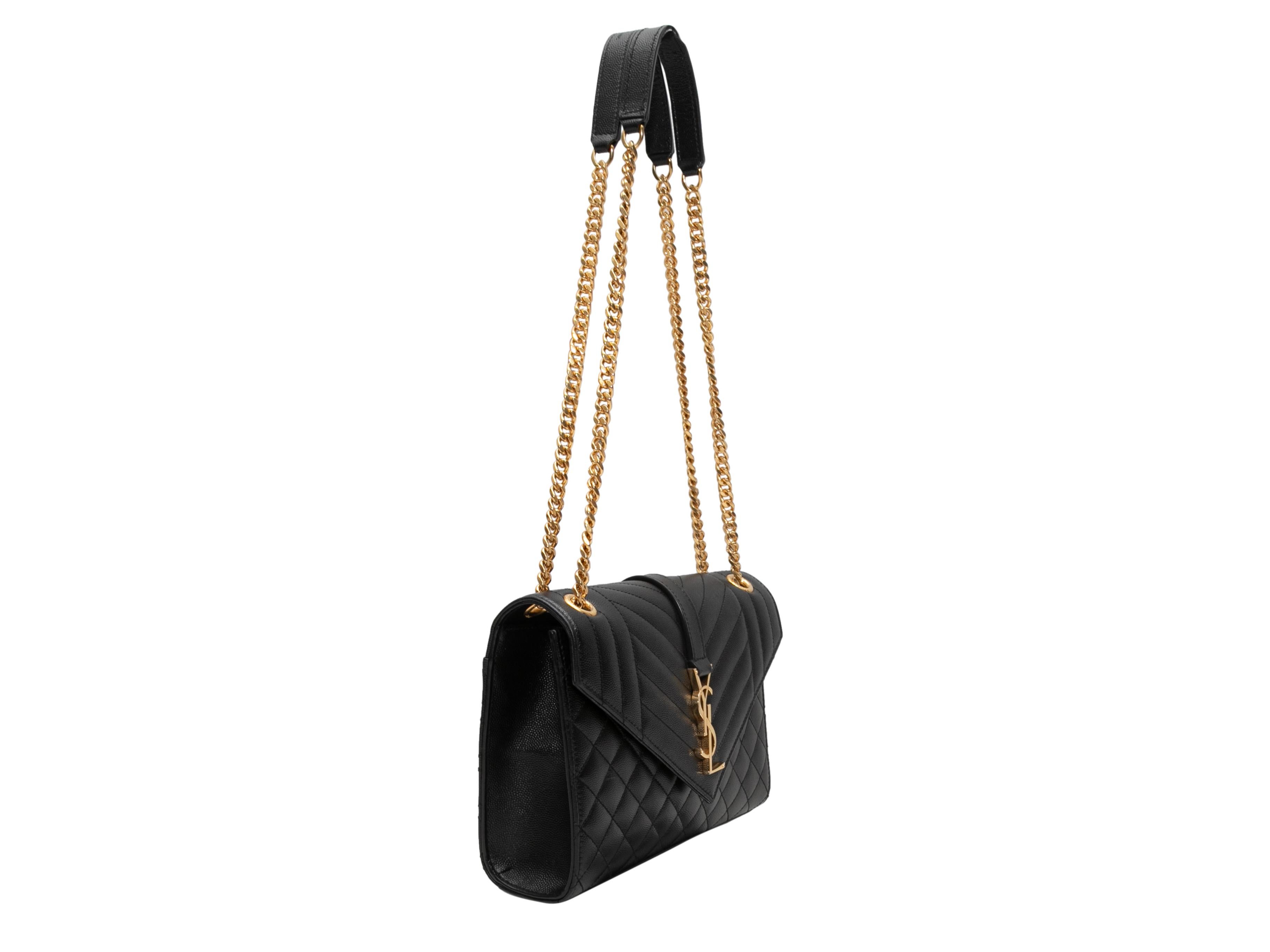 Black Saint Laurent Matelasse Envelope Shoulder Bag. This shoulder bag features a leather body, gold-tone hardware, dual chain-link and leather shoulder straps, and a front flap closure. 10