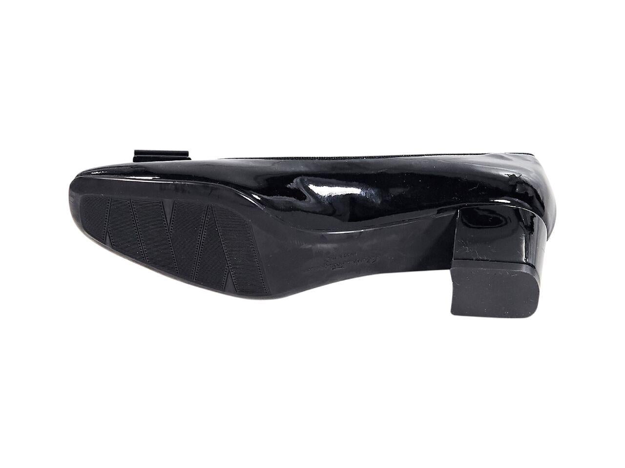 Product details:  Black patent leather kitten heels by Salvatore Ferragamo.  Bow accents vamp.  Block kitten heel.  Slip-on style.  1.75