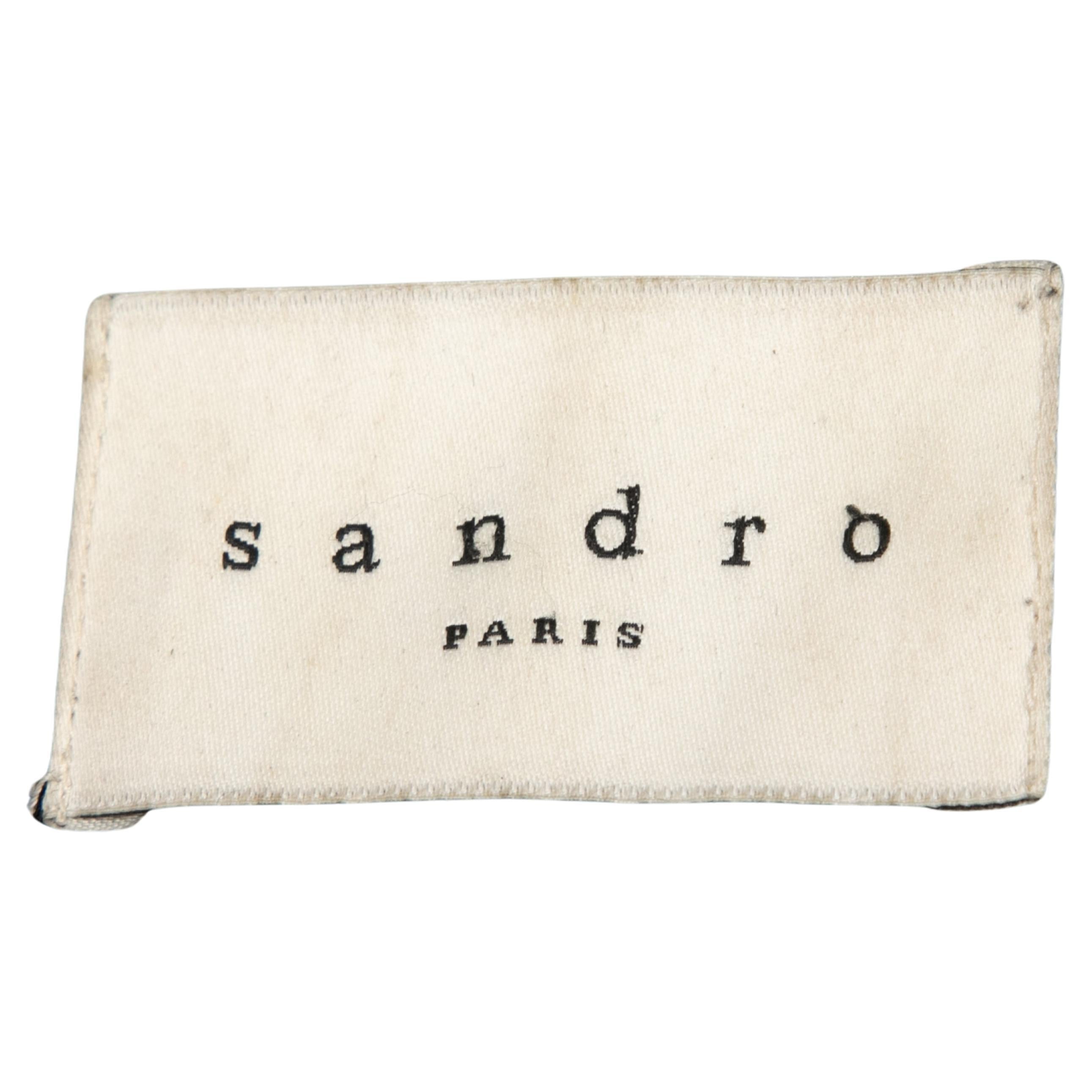 Black layered leather jacket by Sandro. Crew neck. Welt pockets at hips. Front zip closure. 33