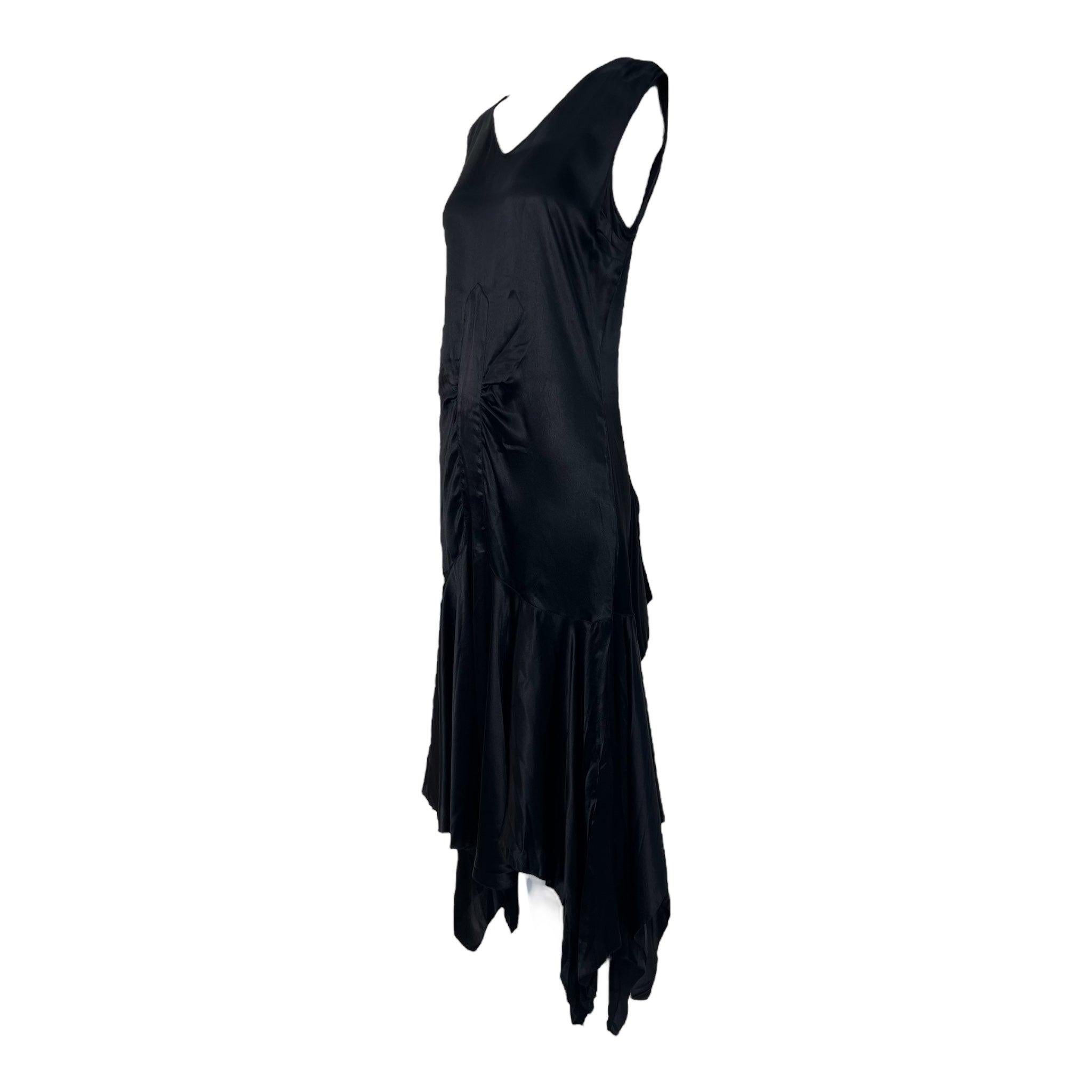 Classic slinky 1920's flapper style little black dress. Drop waist silhouette. Bias cut. Scoop neck and back. Flouncy skirt with bustle gusseting at rear. Beautiful shiny matte-back satin. A piece to treasure in your collection for decades to come.