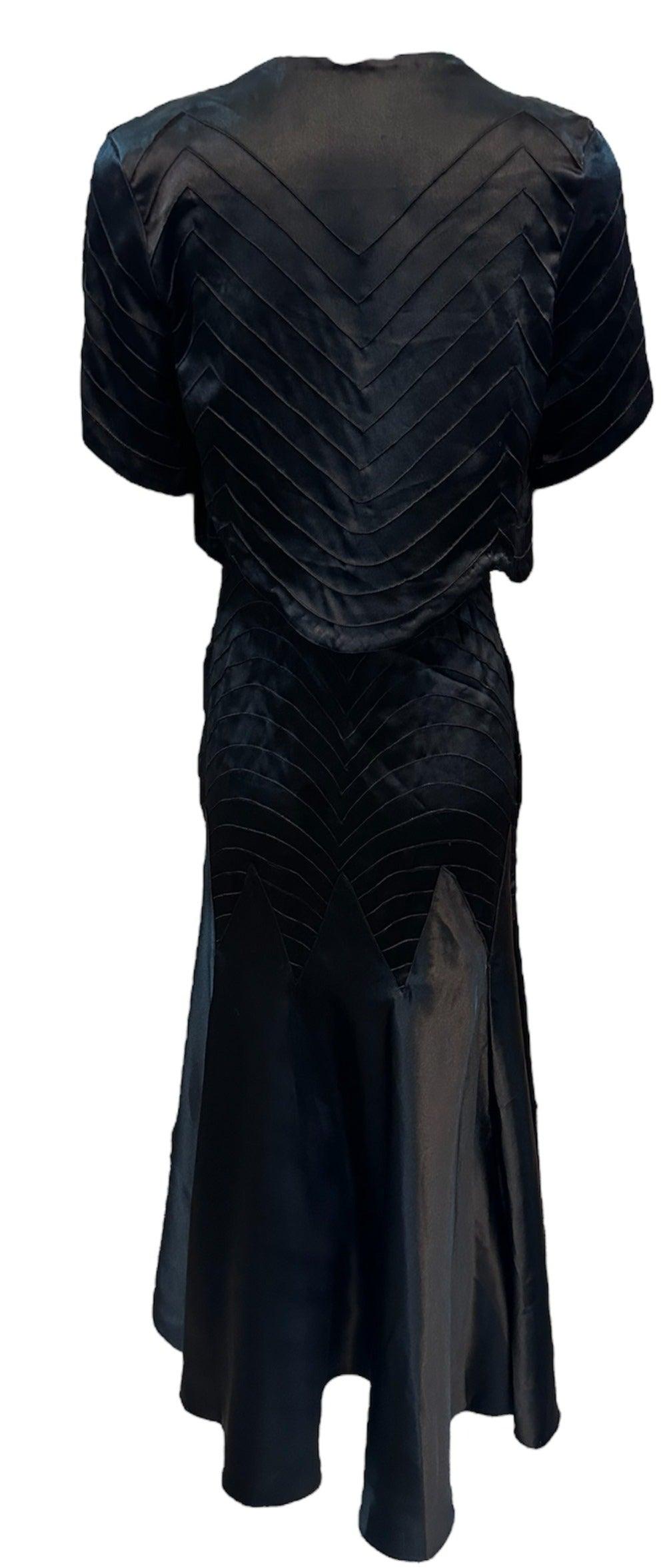 Capture the glamorous spirit of the 1930s with this stunning black satin bias cut gown. Tea length with beaded straps and flared skirt. Matching bolero jacket.  Beautifully constructed with top-stitched seams. Snaps on the side. Lightweight and