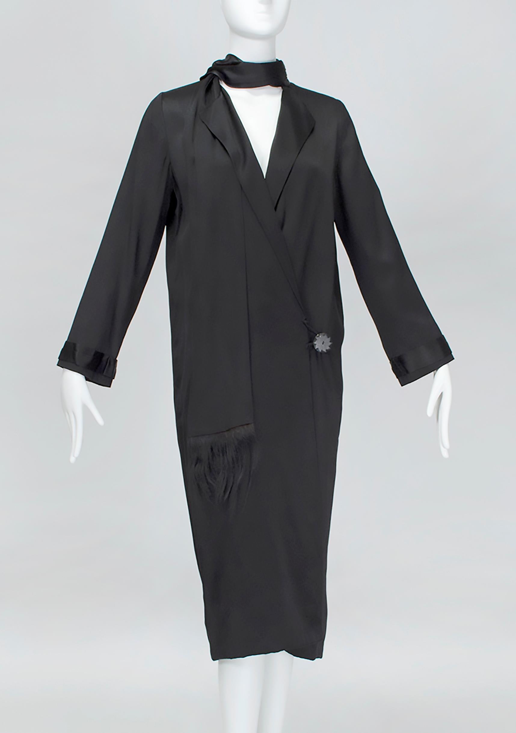 This deconstructed wrap coat is a case study in minimalism, which would have been the perfect foil for a lavishly-beaded, boy-cut chemise dress. The attached neck sash is purposely fixed on one side only so it is easily thrown over the shoulder for