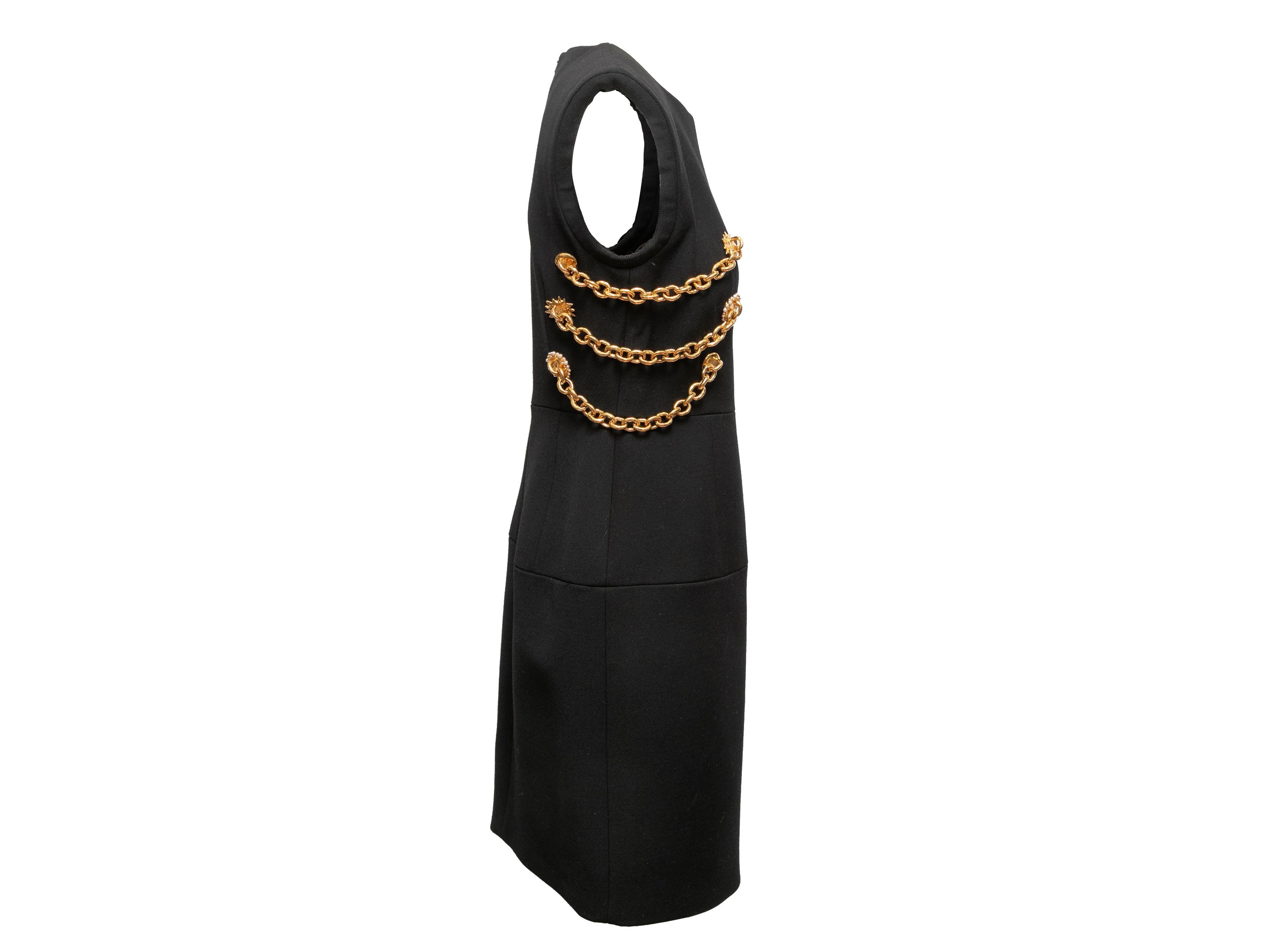 Black Stockman virgin wool sleeveless dress by Schiaparelli. From the Fall/Winter 2023 Collection. Crew neck. Gold-tone chain-link detailing at bodice sides. Zip closure at center back. 33