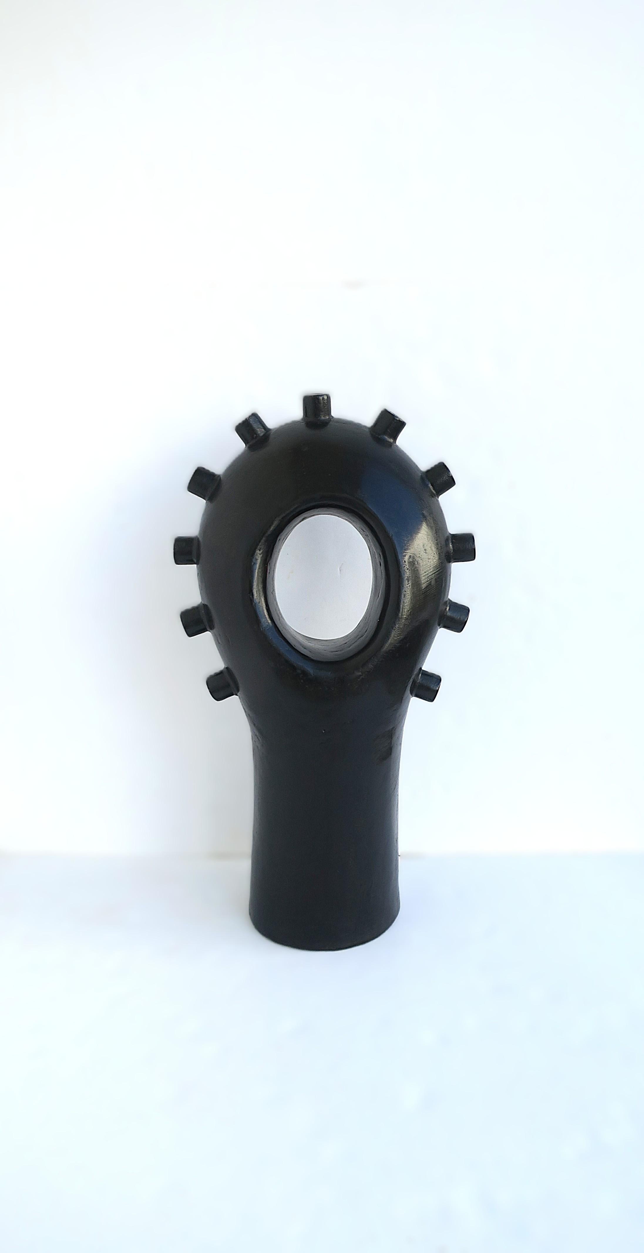 Una scultura nera di dimensioni relativamente grandi in stile moderno o postmoderno, intorno agli anni '70. La scultura ha un design simile a un bullone, un foro ovale al centro e un centro cilindrico. Ottime condizioni, come mostrato nelle