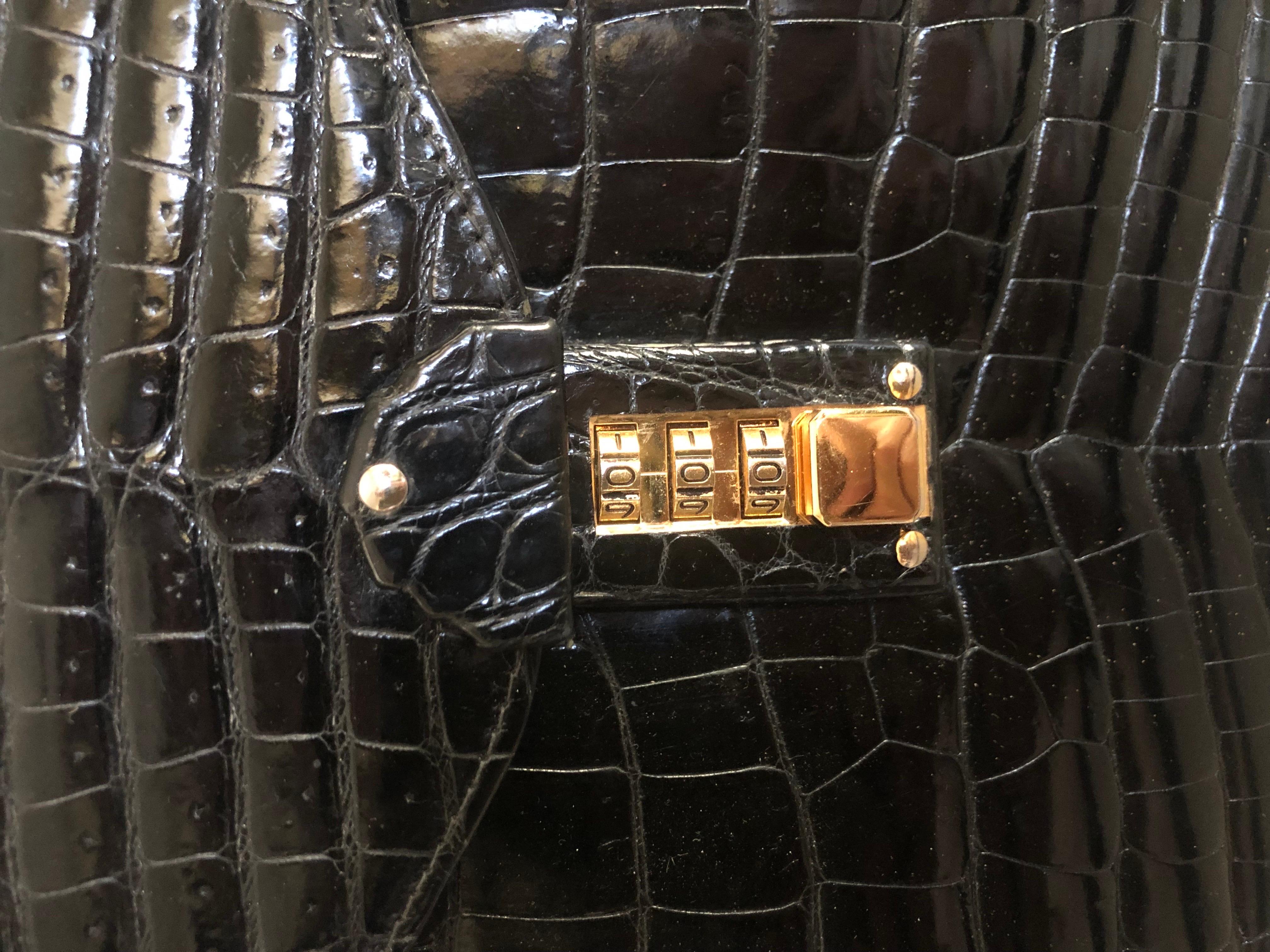 This very chic handbag was purchased in Milan Italy in the 80s at Isanti. and has very little use. It looks like Alligator but it’s made of high-quality Italian black patent leather. Beautiful classic shape with amazing gold hardware. The closure is