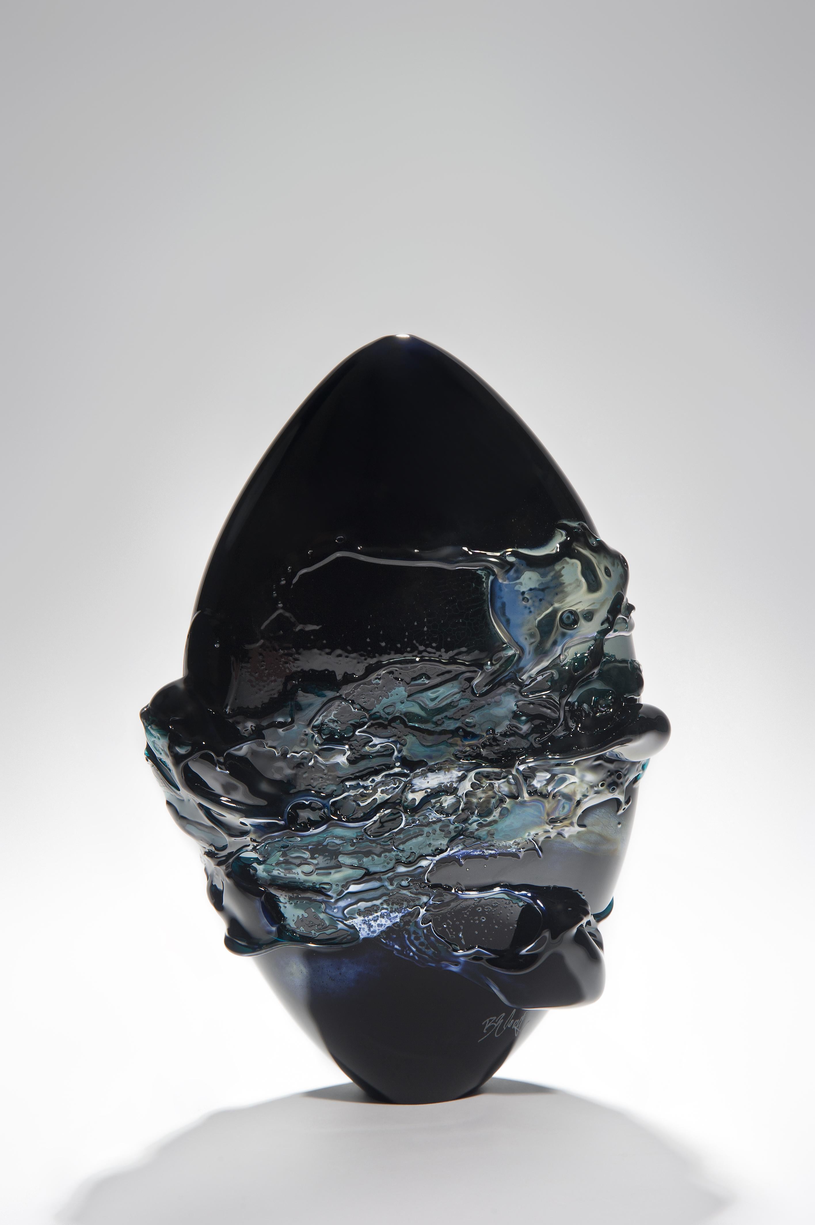 Black Sea is a unique black, blue and metallic sheen glass vase from the Molten Landscapes collection by the British artist Bethany Wood. An equal passion for painting physically inspires how she controls and manipulates her glass. Recreating the