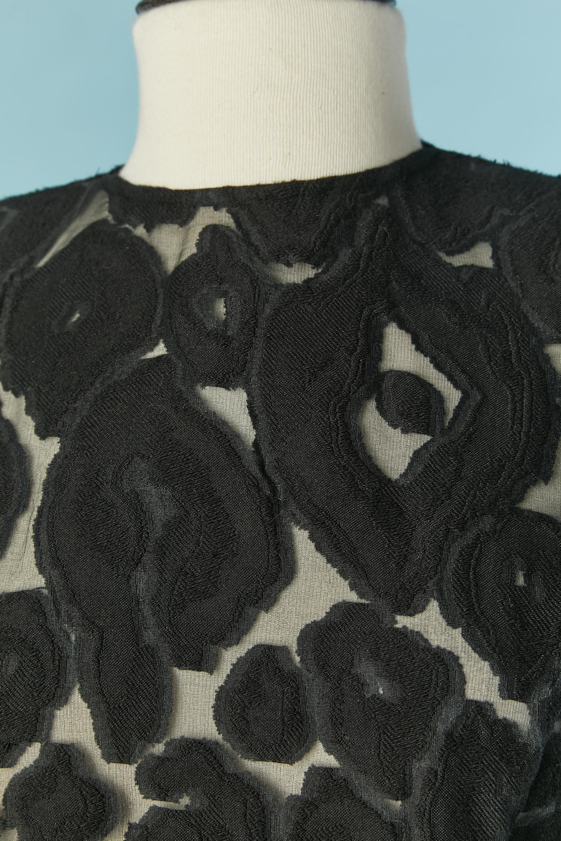 Black see-through cocktail dress made of 
 cotton jacquard dévoré and black velvet edge. The fabric composition tag has been cut. 
Shoulder pad. Zip closure on the middle back. Medusa buttons on the cuffs + buttonhole. 
SIZE L ( the tag has been